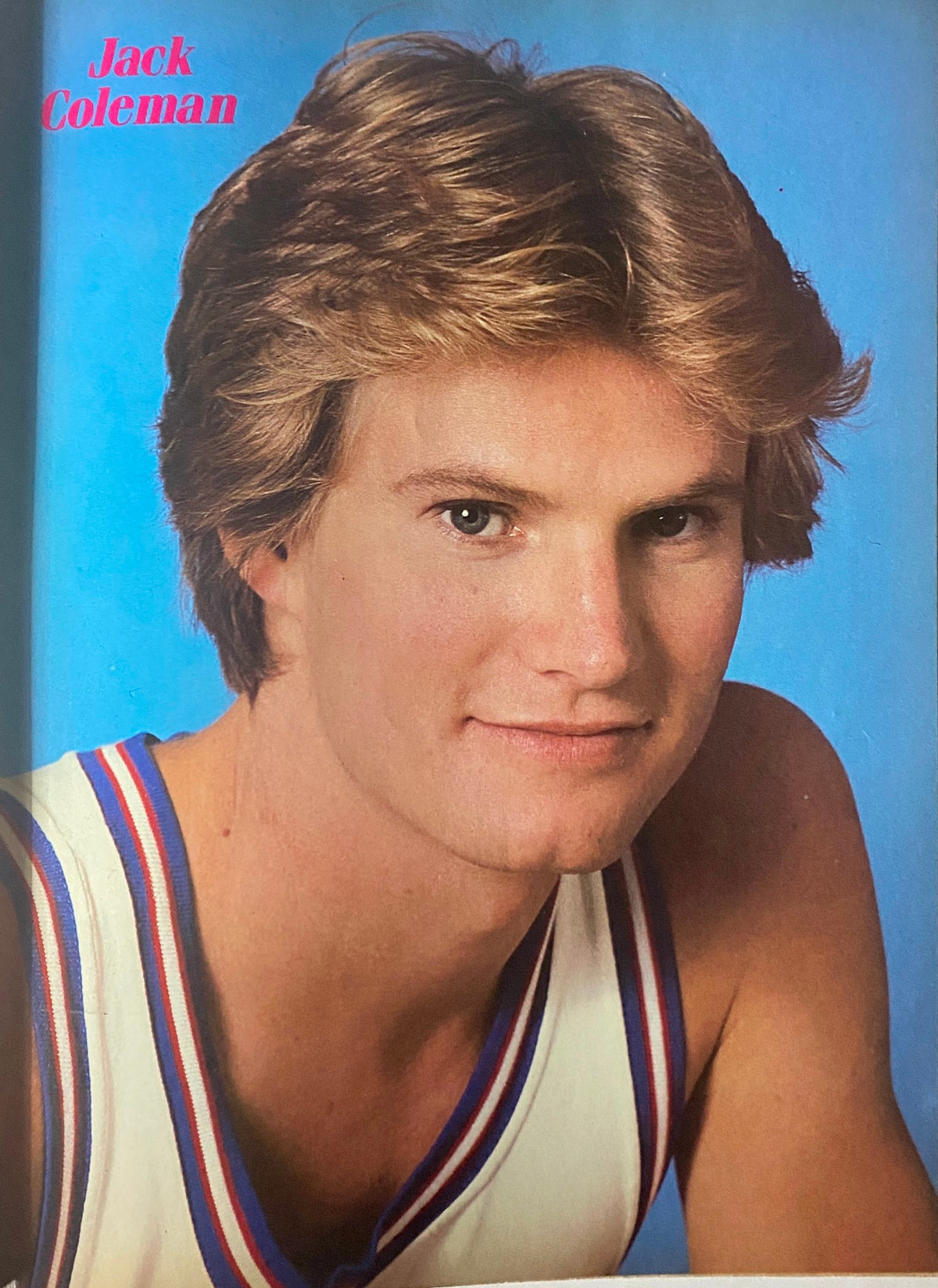 Portrait of Jack Coleman from the February 1982 issue of Tiger Beat Star Magazine showcasing his youthful charm, highlighted against a bright blue background.