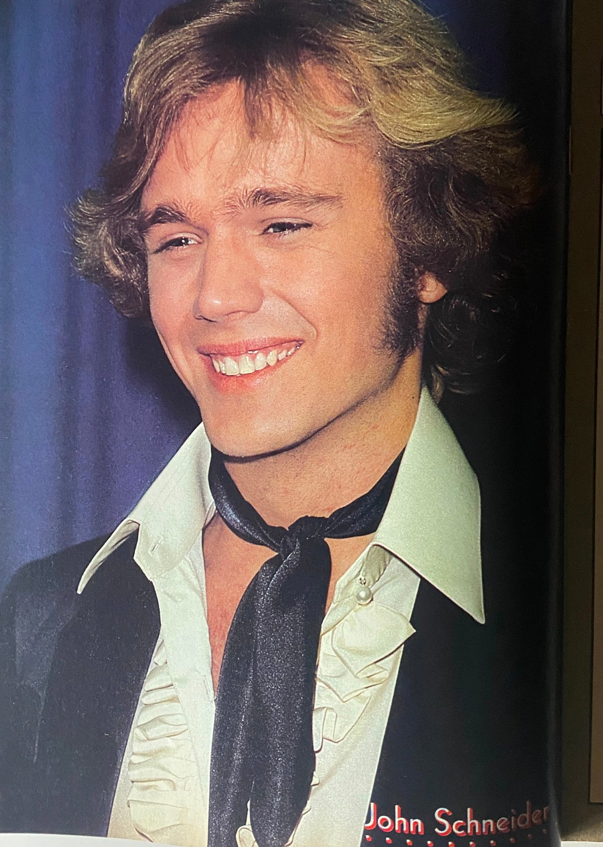 John Schneider featured in a portrait from the June 1981 Tiger Beat Star Magazine, showcasing his iconic hairstyle and charming smile.