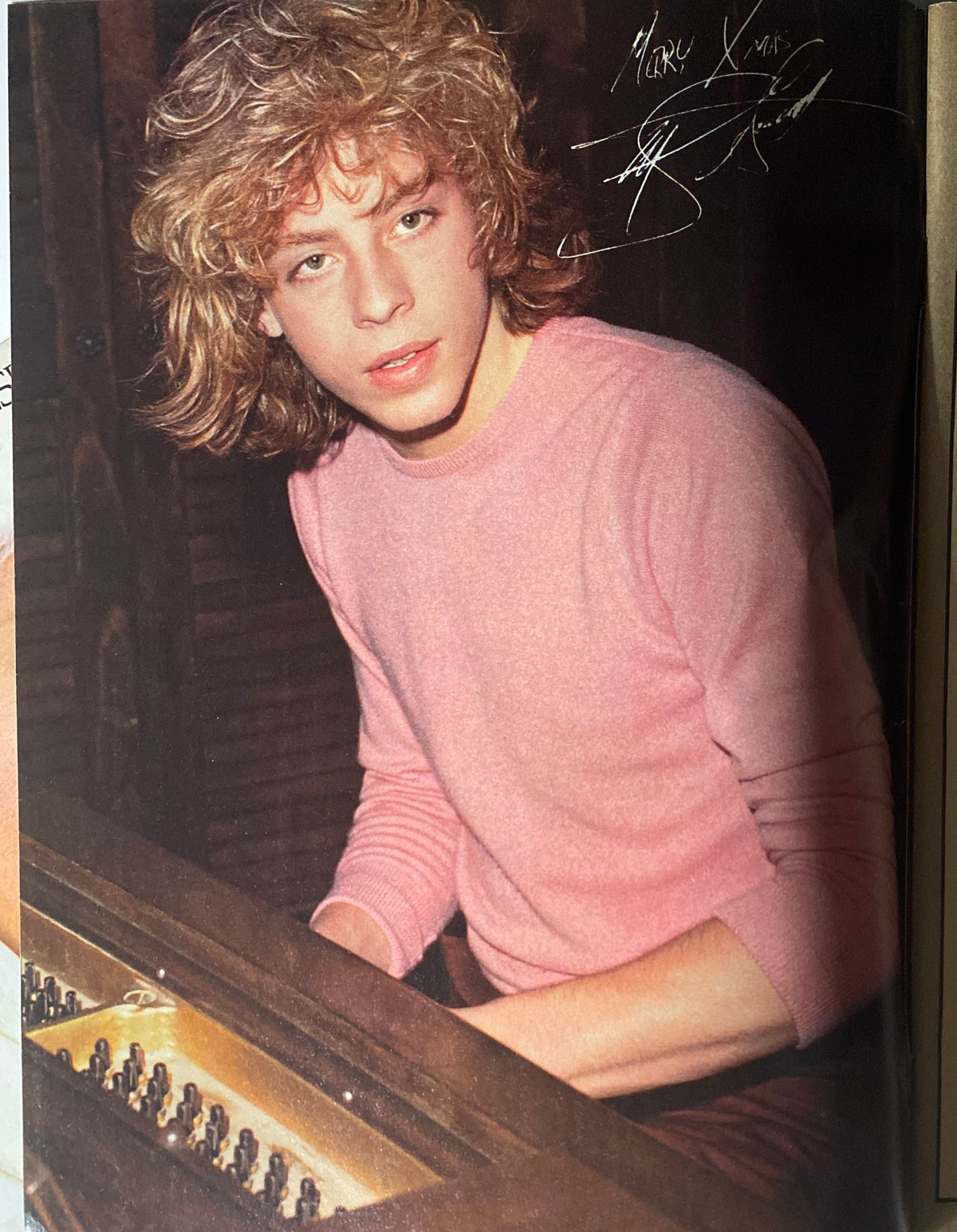 Vintage photo of teen idol with curly hair in a pink sweater featured in January 1981 Tiger Beat Star Super Special.