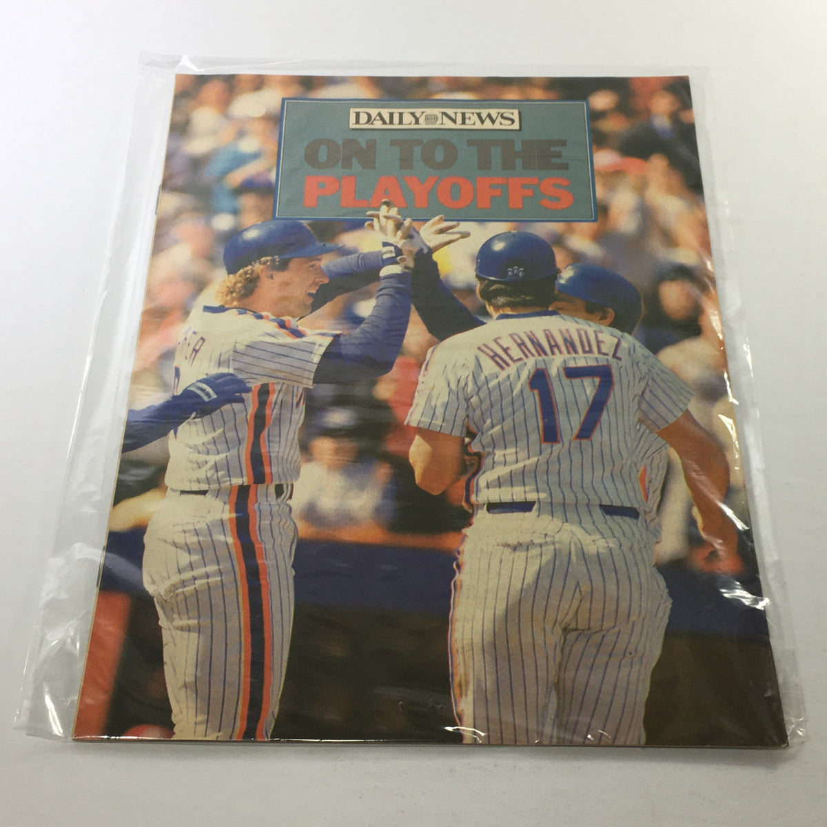 1986 Daily News cover featuring the New York Mets celebrating their playoff qualification at Shea Stadium, showcasing players in striped uniforms with the title 'On To The Playoffs' prominently displayed.