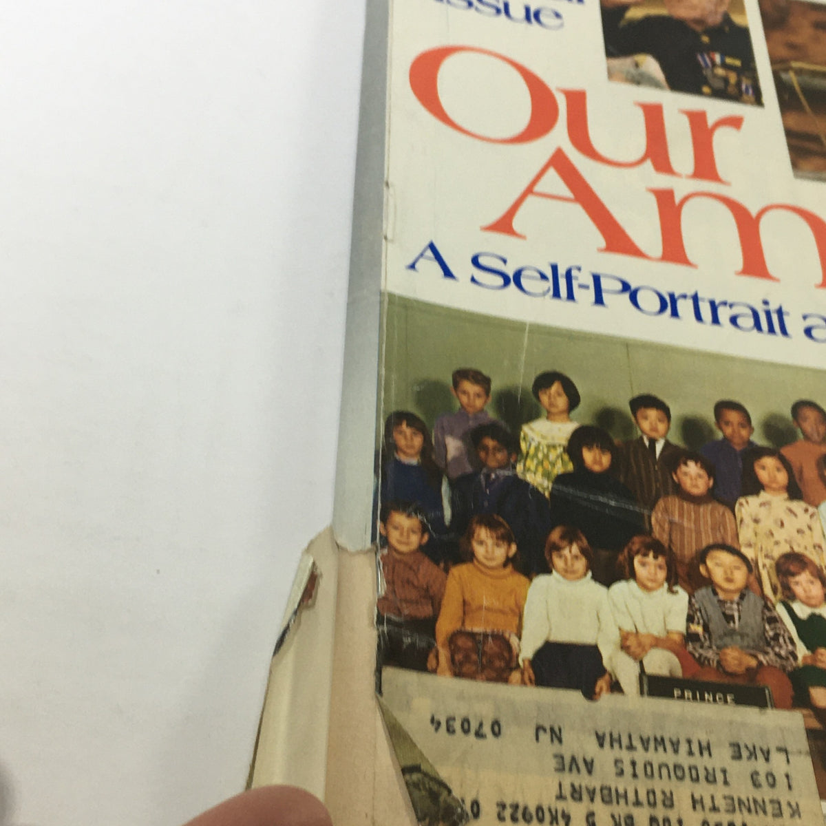 Side view of the Newsweek Magazine, July 4, 1976, displaying the title 'Our America - A Self-Portrait at 200', with visible wear and a sticker label, highlighting its age and historical significance.