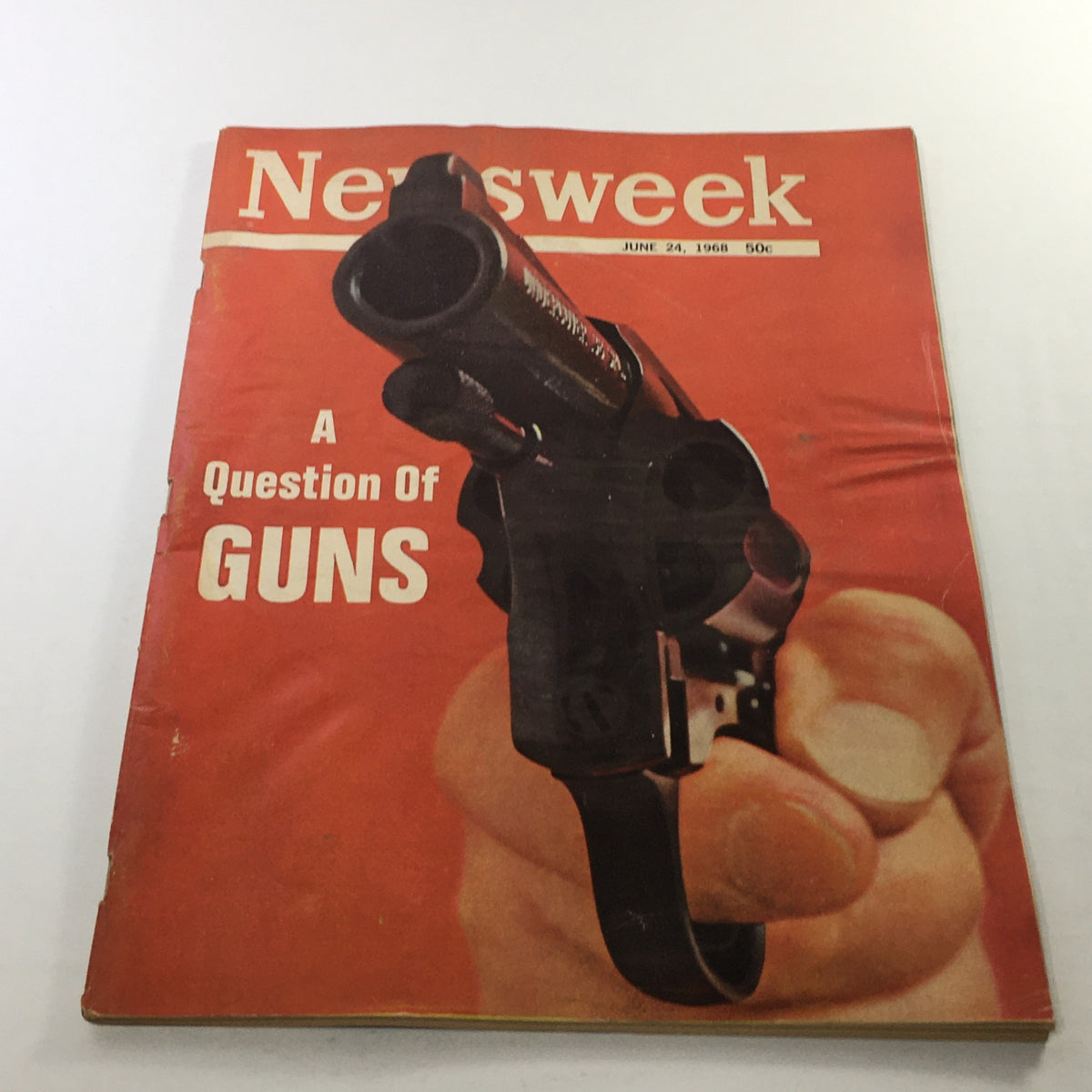 Cover of Newsweek Magazine from June 24, 1968, titled 'A Question Of Guns,' featuring an image of a firearm held by a hand with a vintage design.