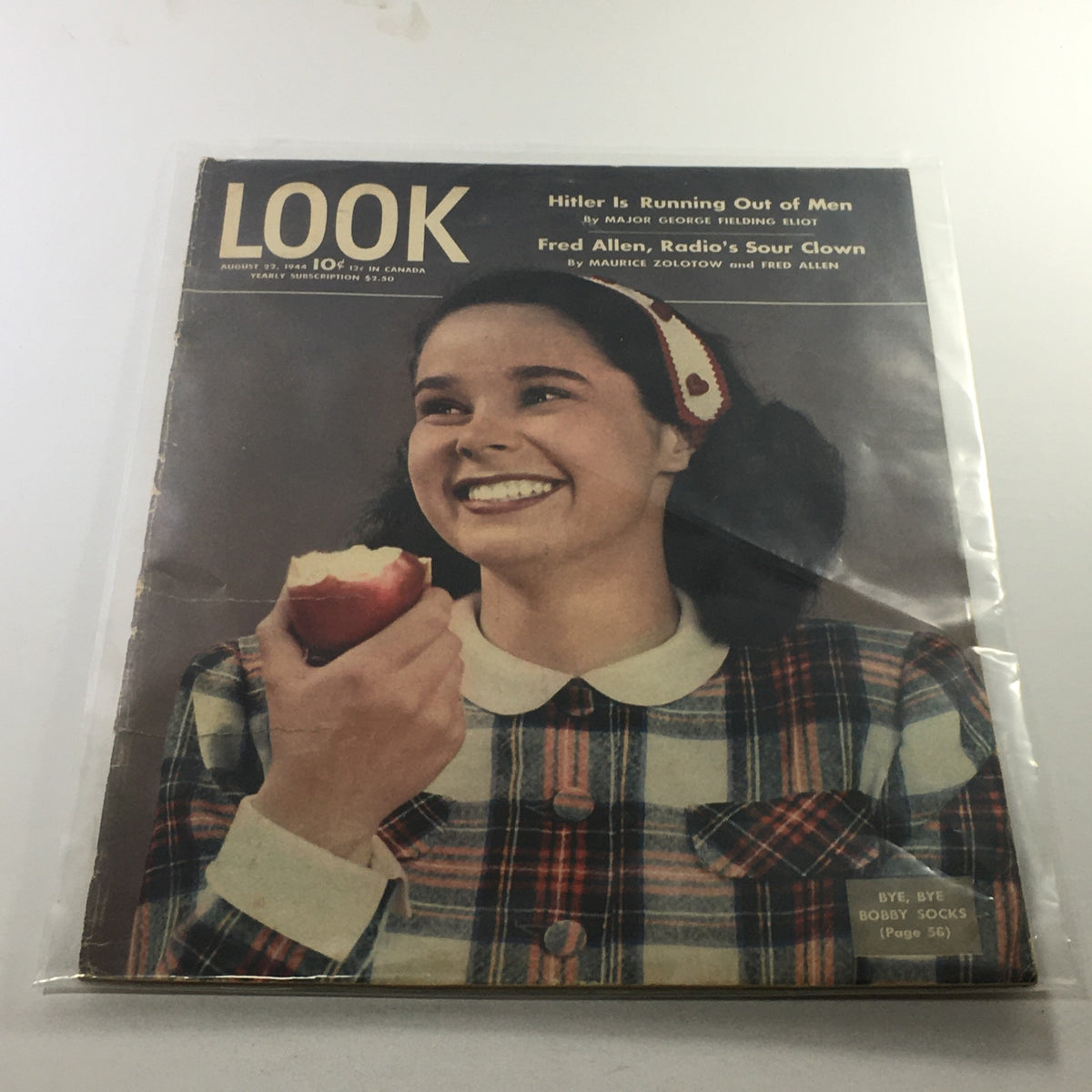 Cover of Look Magazine: August 22, 1944 featuring the title 'Hitler Is Running Out Of Men' and a smiling girl holding an apple, highlighting Fred Allen as Radio's Sour Clown.