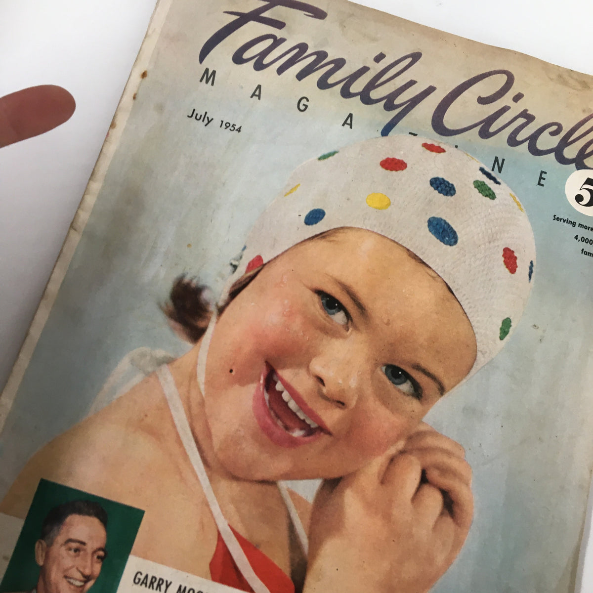 Cover page of VTG Family Circle Magazine July 1954 featuring a young girl in a colorful swim cap and playful expression, showcasing vintage charm.