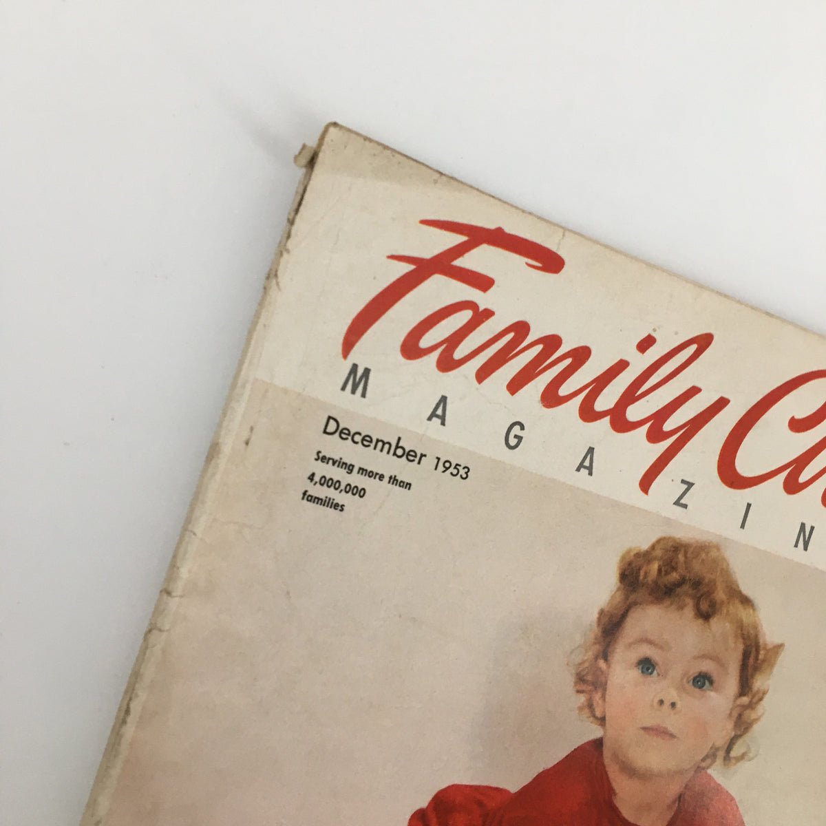 Close-up of Vintage Family Circle Magazine December 1953 cover highlighting the magazine's title and date along with a child's portrait.