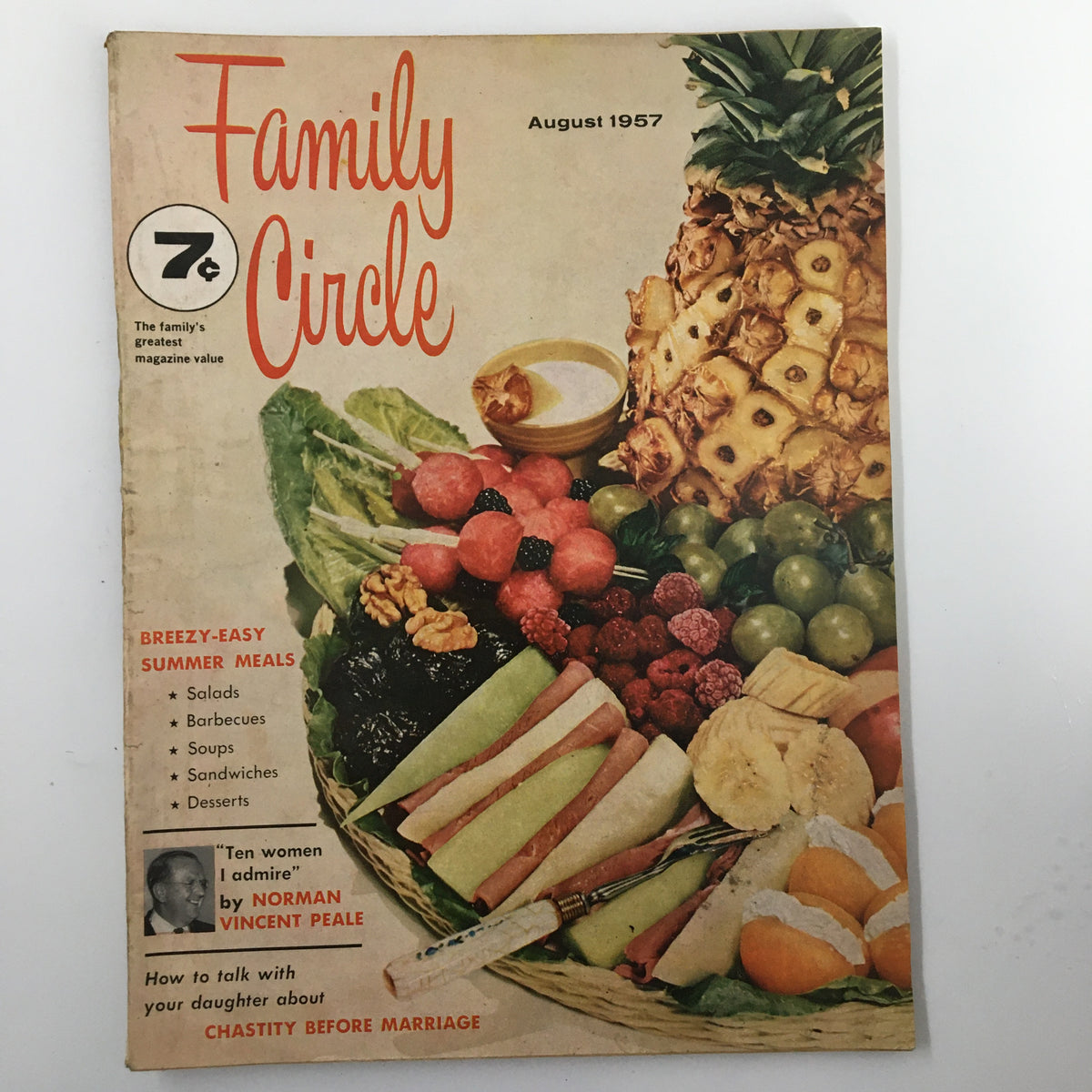 Cover of the August 1957 issue of Family Circle magazine featuring a colorful array of fruits and salads, highlighting breezy summer meals and the theme of chastity before marriage.