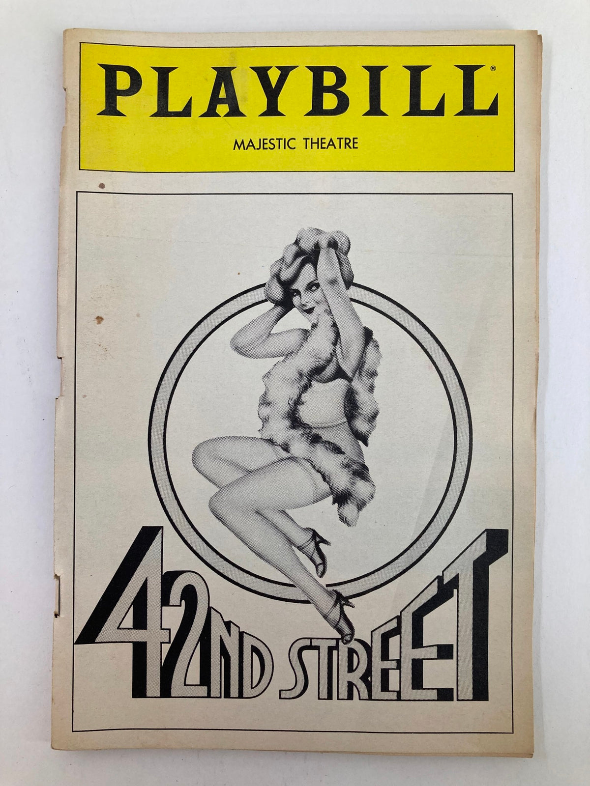 1983 Playbill from the Majestic Theatre featuring the musical 42nd Street, showcasing a vintage cover design with an illustration of a dancer in a fur outfit.