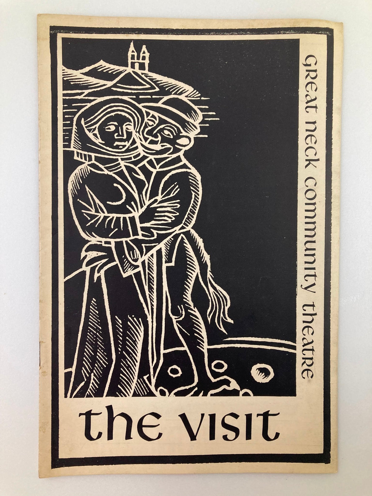 1963 Great Neck Community Theatre Program cover for The Visit by Friedrich Duerrenmatt featuring a woodcut design of a couple embracing against a scenic backdrop.