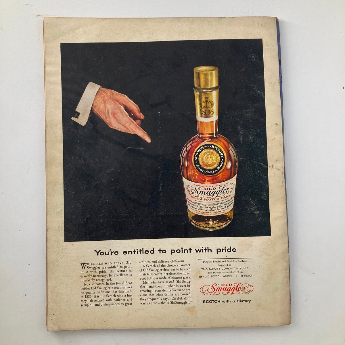 Back cover of VTG Esquire Magazine April 1956 displaying an advertisement for Old Smuggler Scotch Whisky, highlighting its heritage and quality.