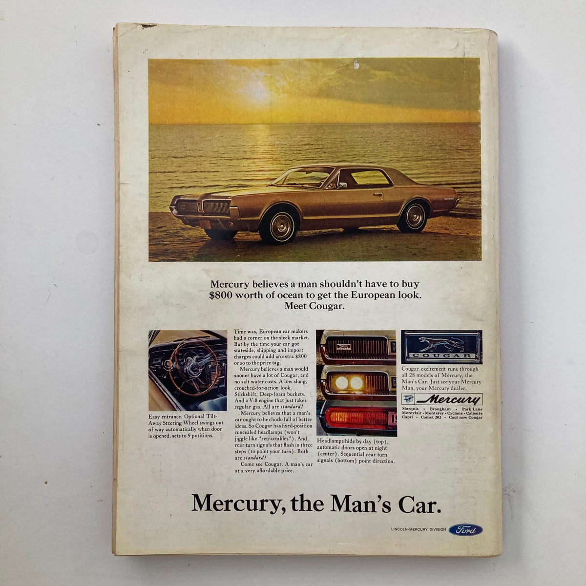 Back cover of VTG Playboy Magazine December 1966 featuring a classic Mercury Cougar advertisement, promoting the car with a scenic ocean view.