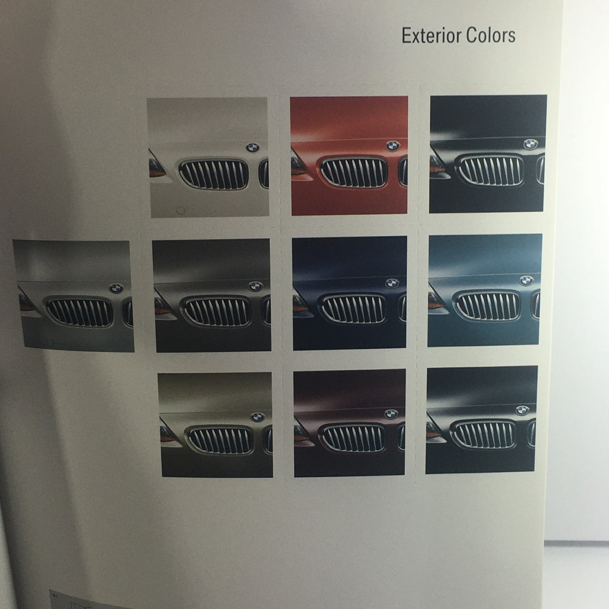 Page from the 2004 BMW Z4 Roadster 2.5i 3.0i Dealership Car Auto Brochure, illustrating a selection of exterior color options for the BMW Z4.