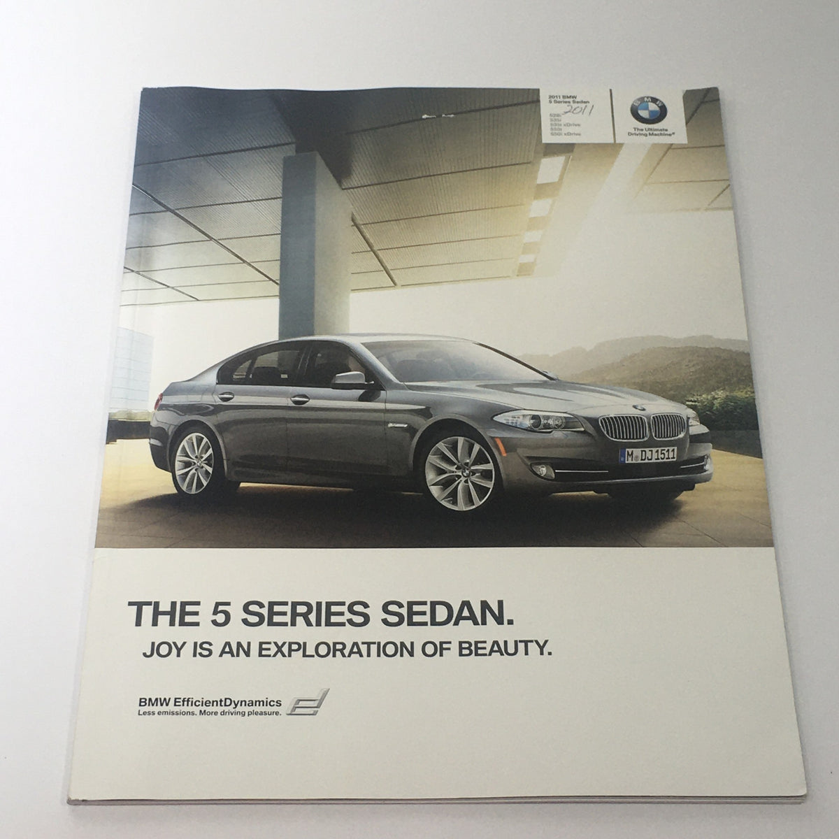 2011 BMW 5 Series Sedan brochure cover showcasing the luxury and style of the 528i, 535i, and 550i models.