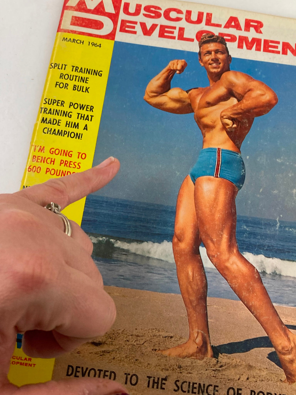 Close-up of the cover of VTG Muscular Development Magazine March 1964 Vol 1 #3 with Bernie Ernst, highlighting articles on bodybuilding and fitness routines.