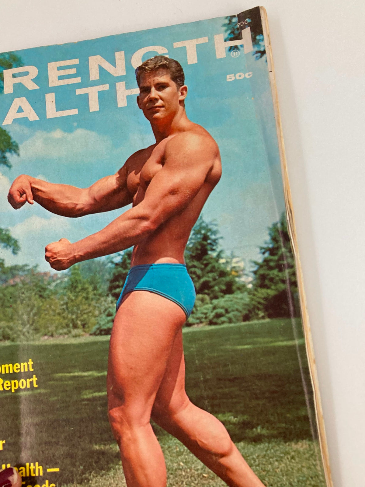 Close-up view of VTG Strength & Health Magazine November 1967 cover featuring Mike Dayton flexing his muscles, emphasizing fitness culture from the 1960s.