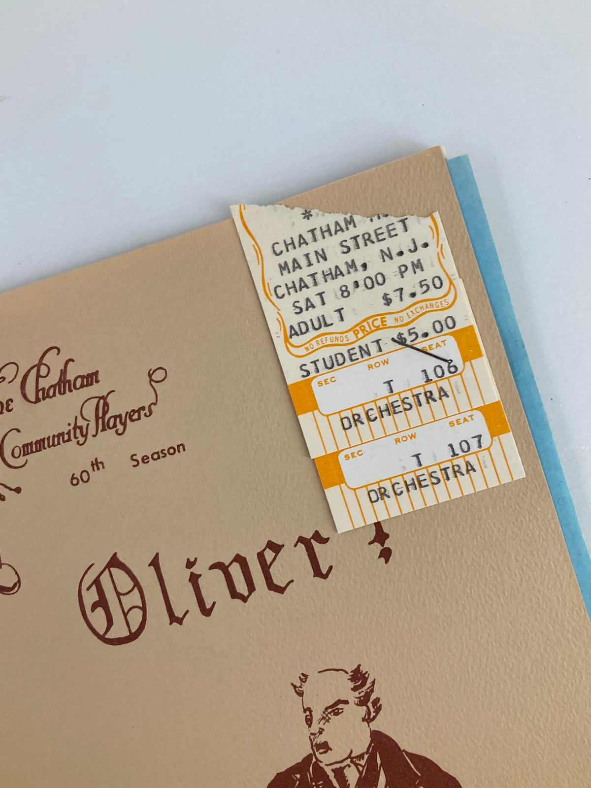 Close-up of the ticket stub attached to the 1981 The Chatham Community Players Program for Oliver! Details of the ticket for a performance at the Chatham Main Street theater.