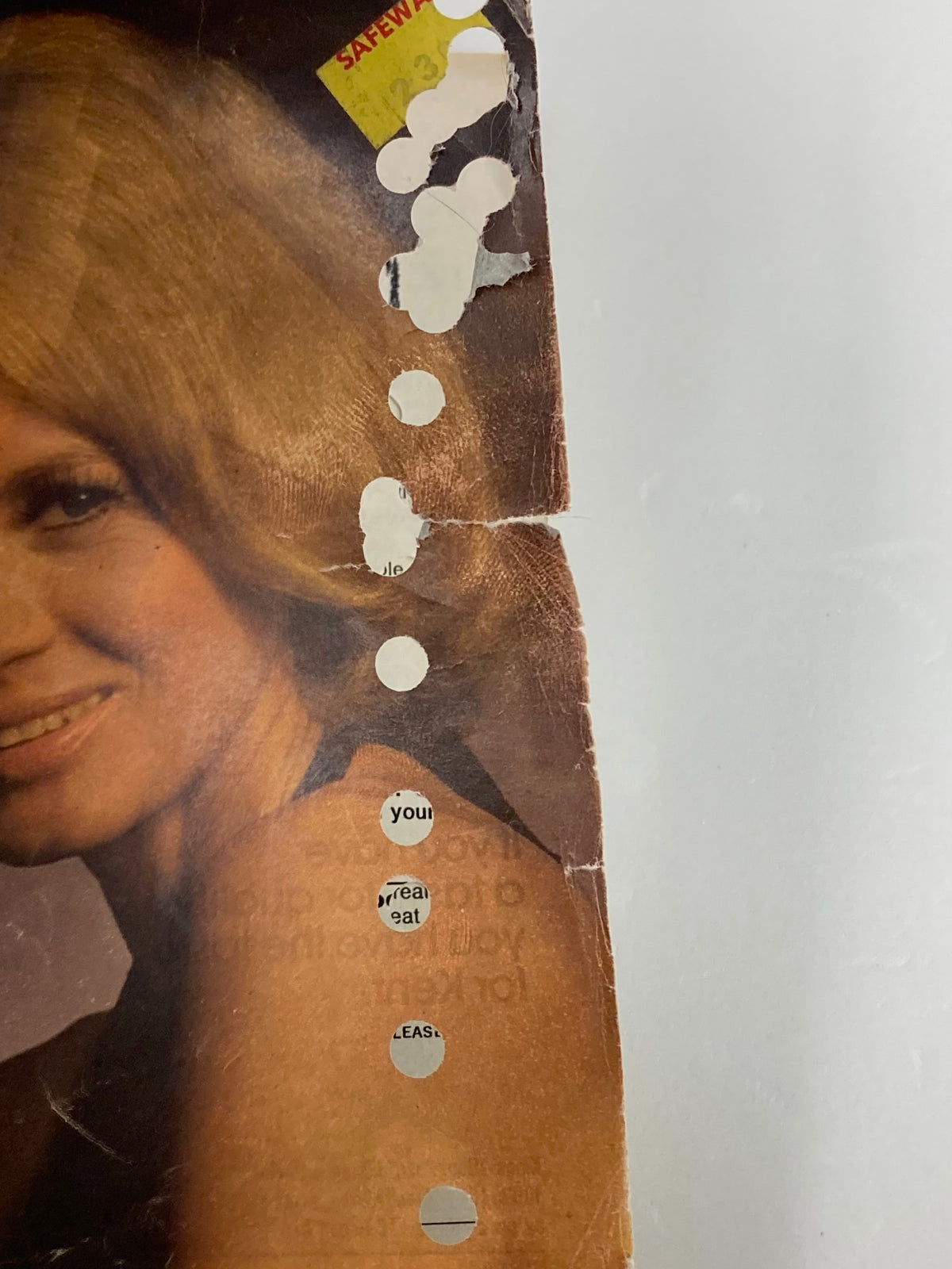 Close-up of the side edge of TV Guide Magazine January 4 1975, highlighting vintage wear including hole punches, a price sticker, and creases.