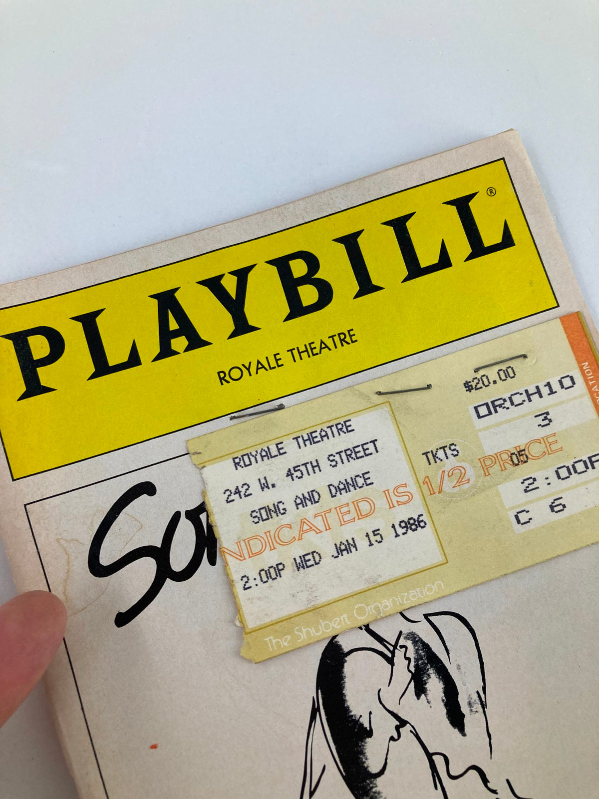 Close-up view of the 1986 Playbill from Royale Theatre, highlighting the ticket for Song & Dance with performance details.