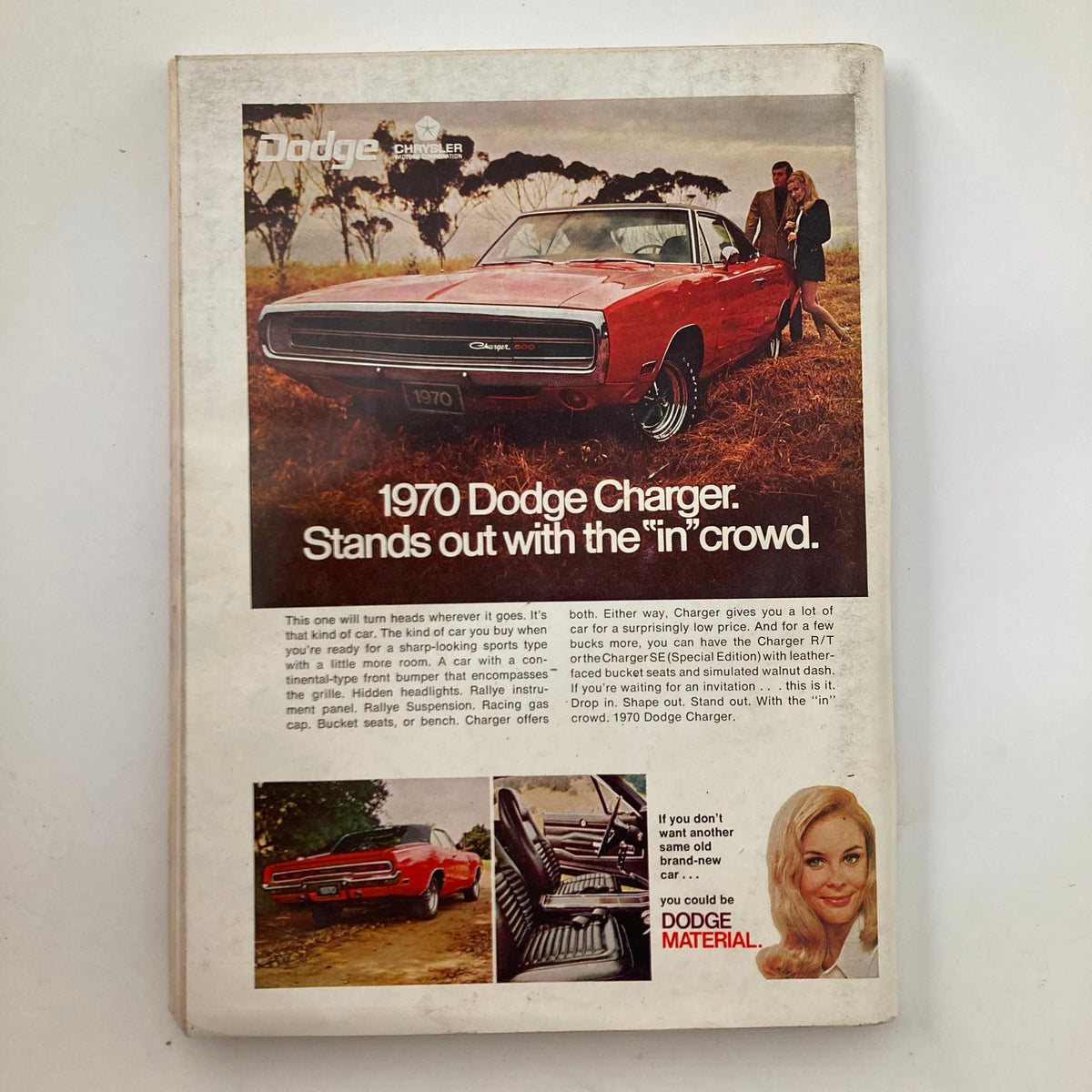 Back cover of the December 1969 Playboy magazine featuring an advertisement for the 1970 Dodge Charger, showcasing the car alongside a couple in a vintage setting.