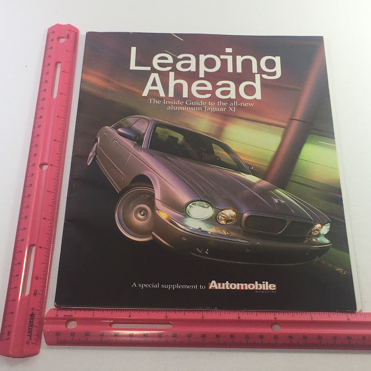 2000 Jaguar Automobile Magazine Dealership Car Auto Brochure Catalog cover shown with a ruler for size reference, highlighting the title 'Leaping Ahead'.