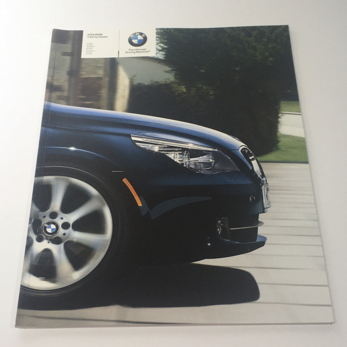 2008 BMW 5 Series Sedan 528i 528xi 535i Dealership Car Auto Brochure Catalog covering the front of a BMW vehicle, showcasing sleek design and stylish alloy wheels.