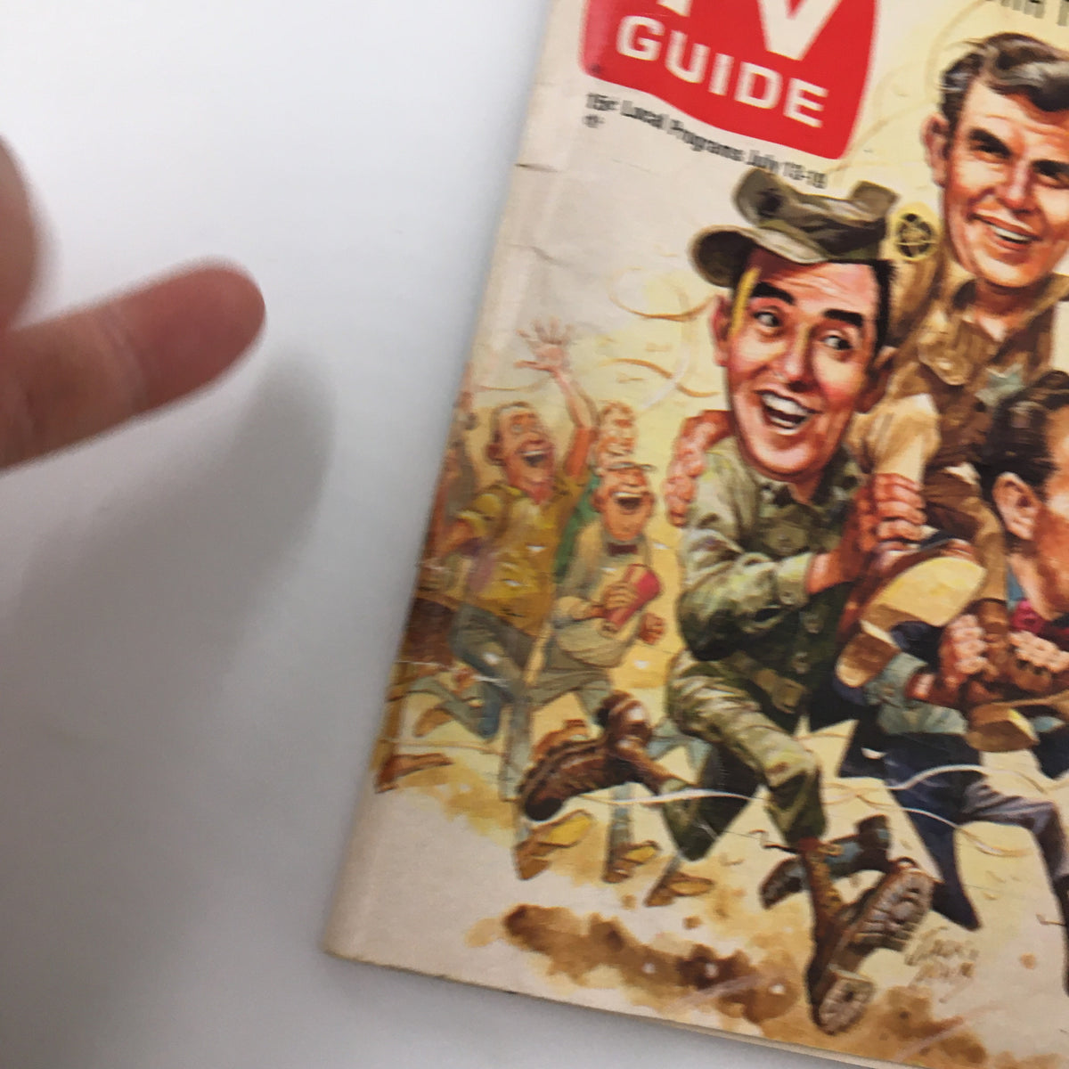 Close-up view of the cover of TV Guide Magazine July 13, 1968 showcasing cartoon illustrations of popular television characters from the era.
