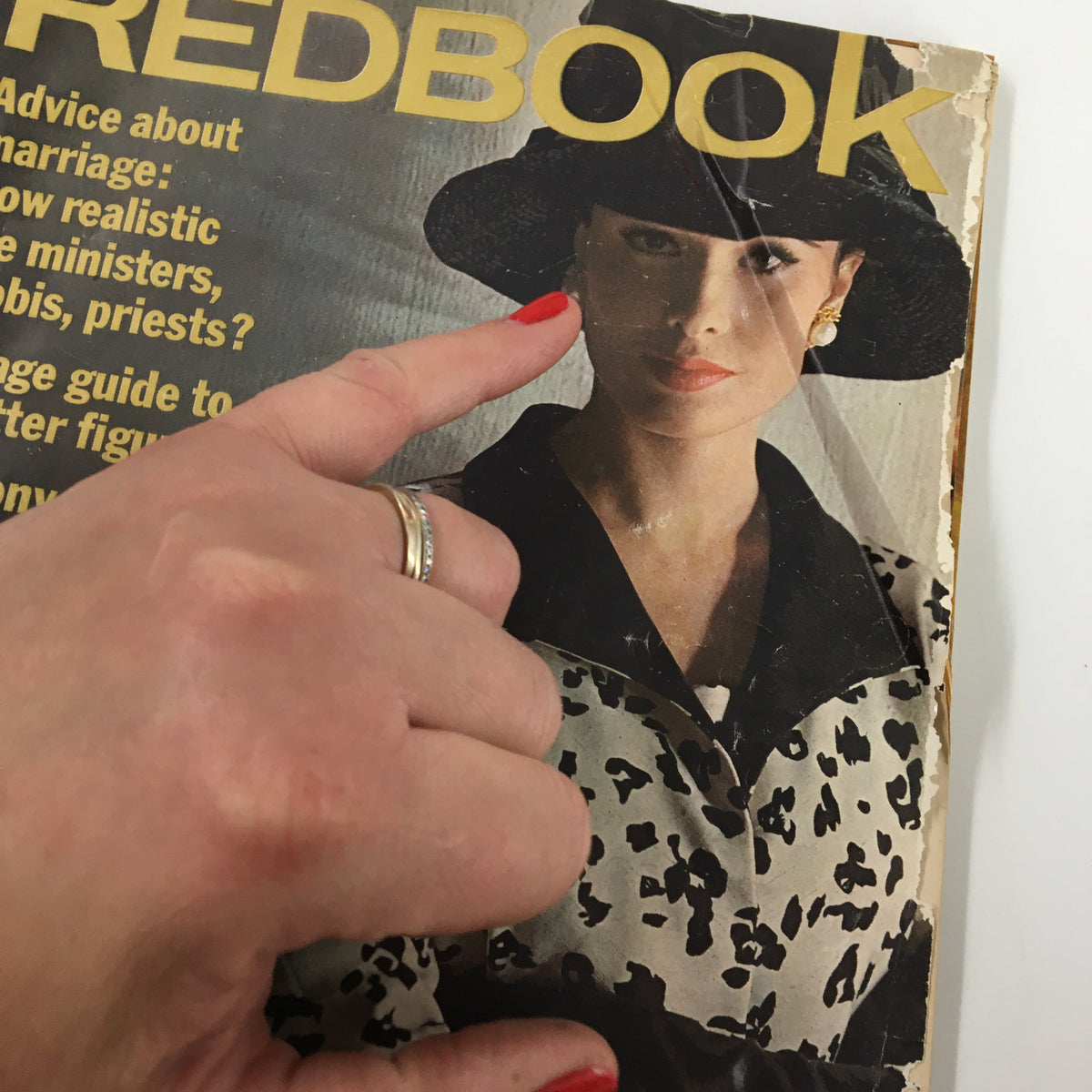 Close-up of the cover of VTG Redbook Magazine March 1963 with a hand pointing to the woman's face, showcasing features like marriage advice and a guide to self-improvement.