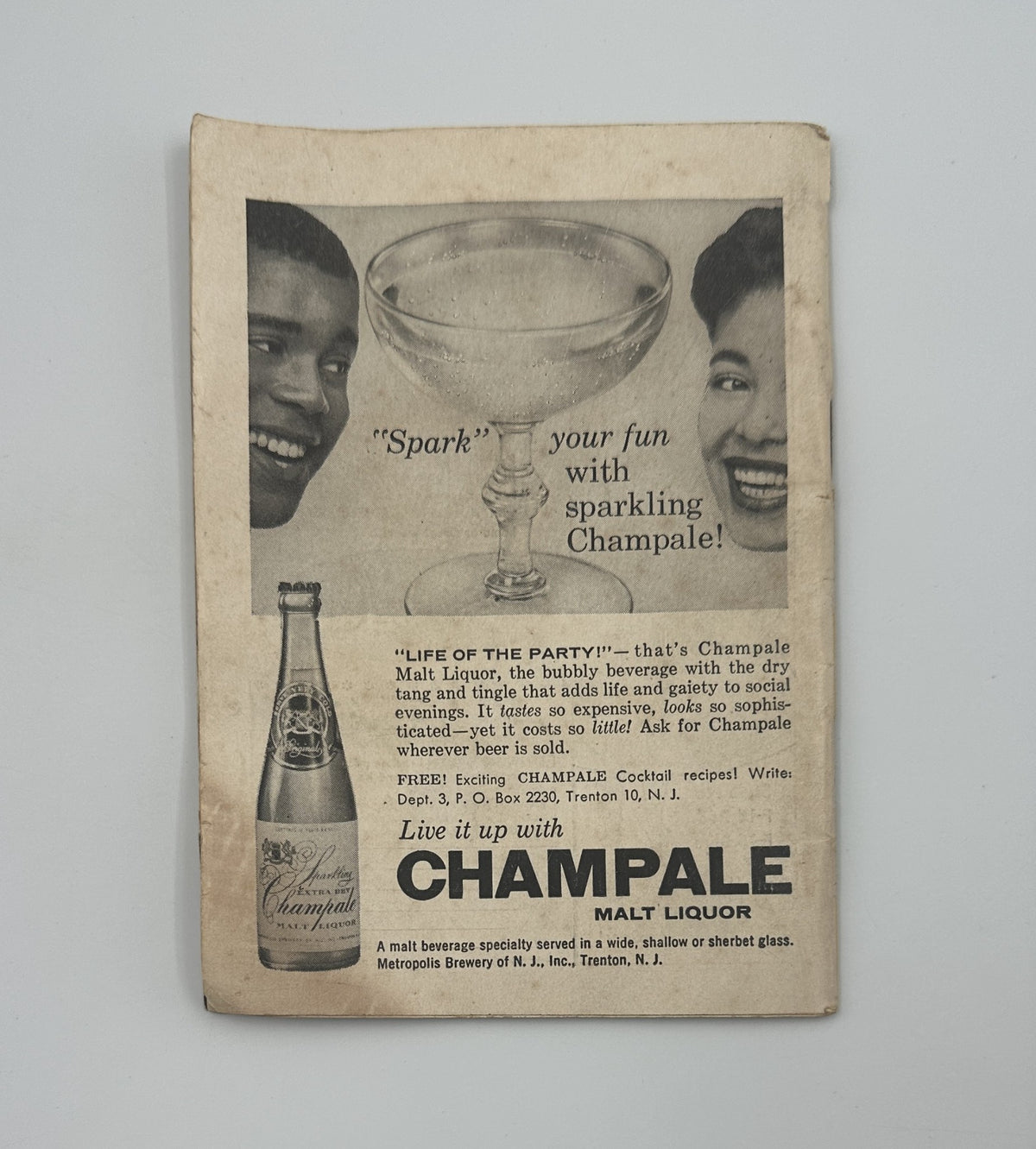 Advertisement from Jet Magazine, August 15, 1957, promoting Champale malt liquor, featuring two smiling individuals.