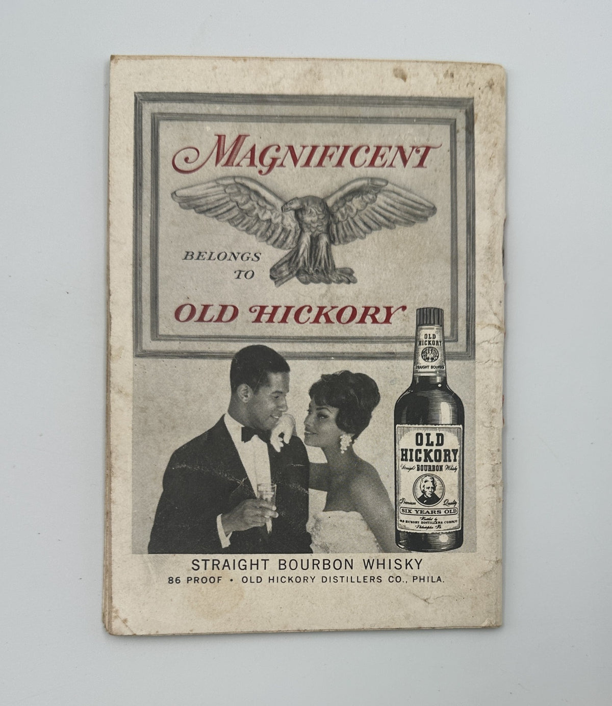 Advertisement for Old Hickory Bourbon in Jet Magazine, showcasing a couple dressed elegantly, highlighting the spirit's branding and association with sophistication.