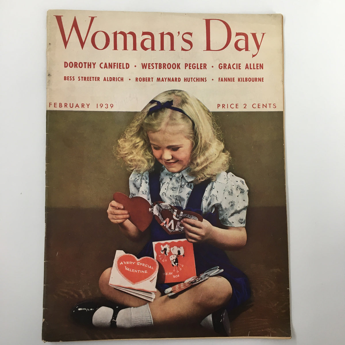 VTG Woman's Day Magazine February 1939 cover featuring a young girl delightfully examining Valentine's cards, showcasing vintage design and nostalgia.