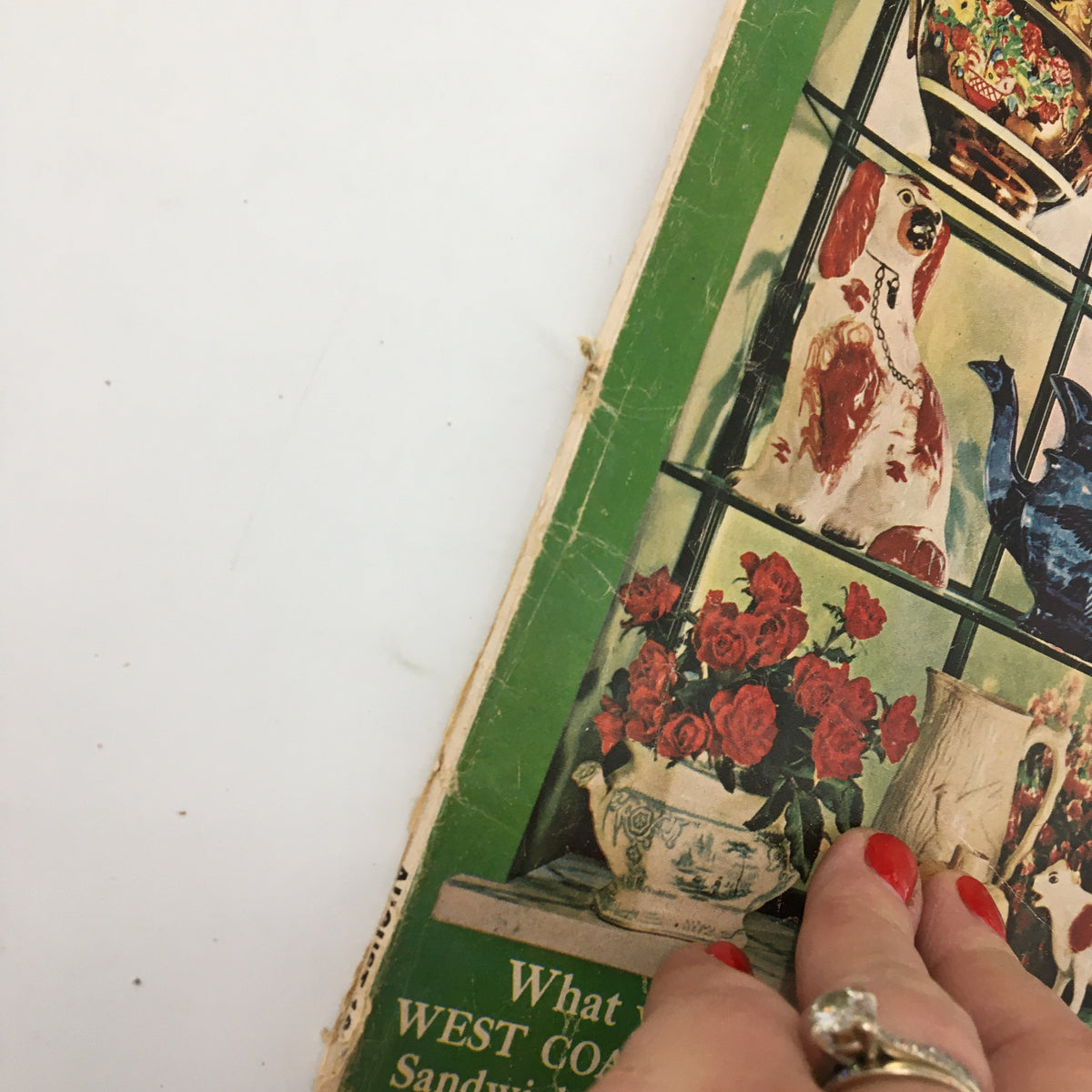 Side view of the VTG Woman's Day Magazine August 1962, highlighting the vintage wear and tear on the cover, featuring decorative flowers and items from its article 'The Loneliest Woman in Town'.
