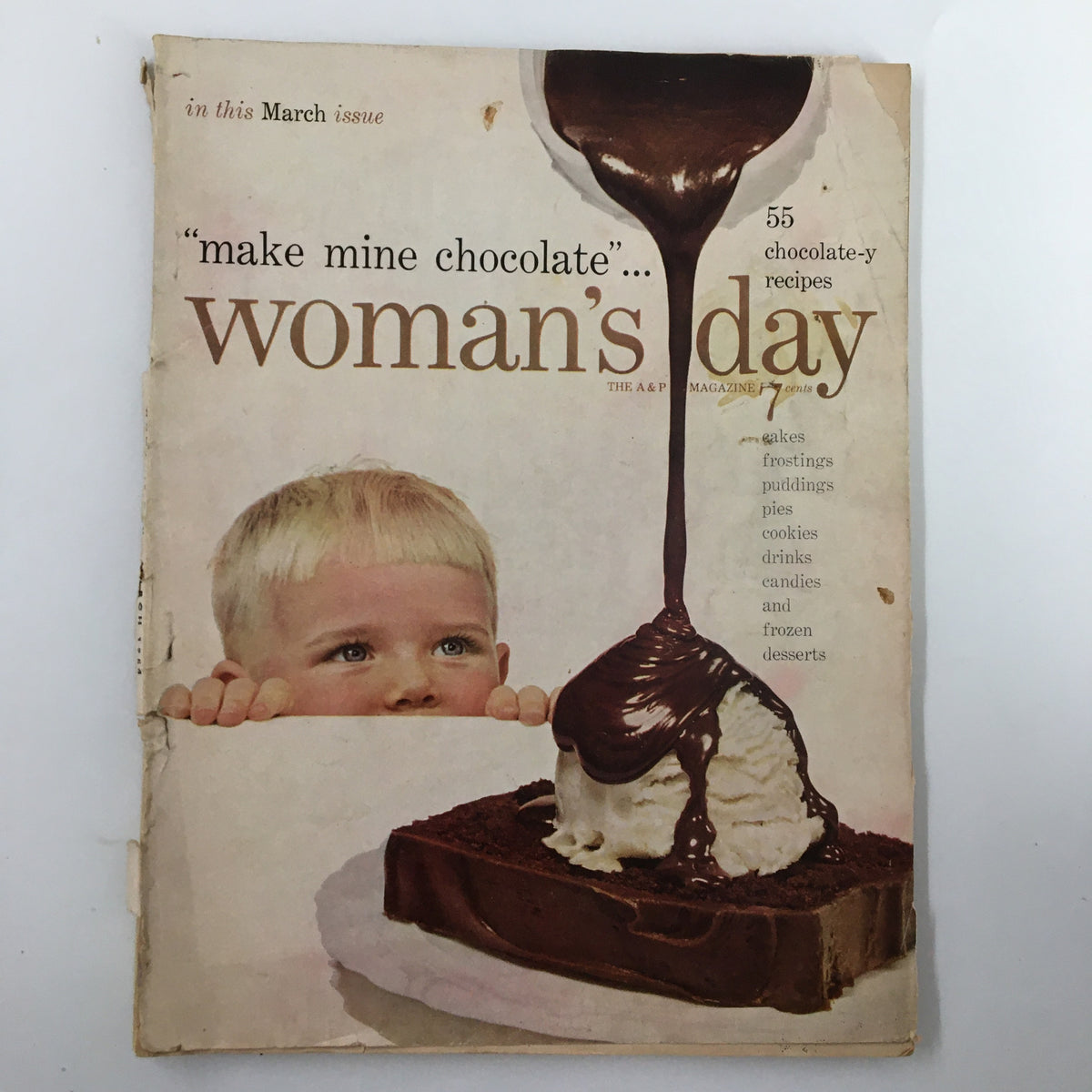 Cover of VTG Woman's Day Magazine March 1954 featuring a child peeking over a table at a chocolate dessert, showcasing the issue's theme of chocolate recipes.