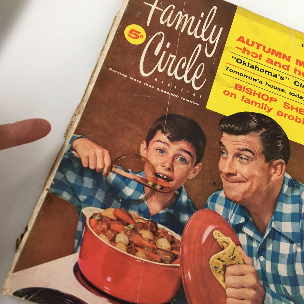 Close-up of the cover of VTG Family Circle Magazine October 1955, highlighting the article 'The Tightwad Millionaire' with a boy and man eating together.