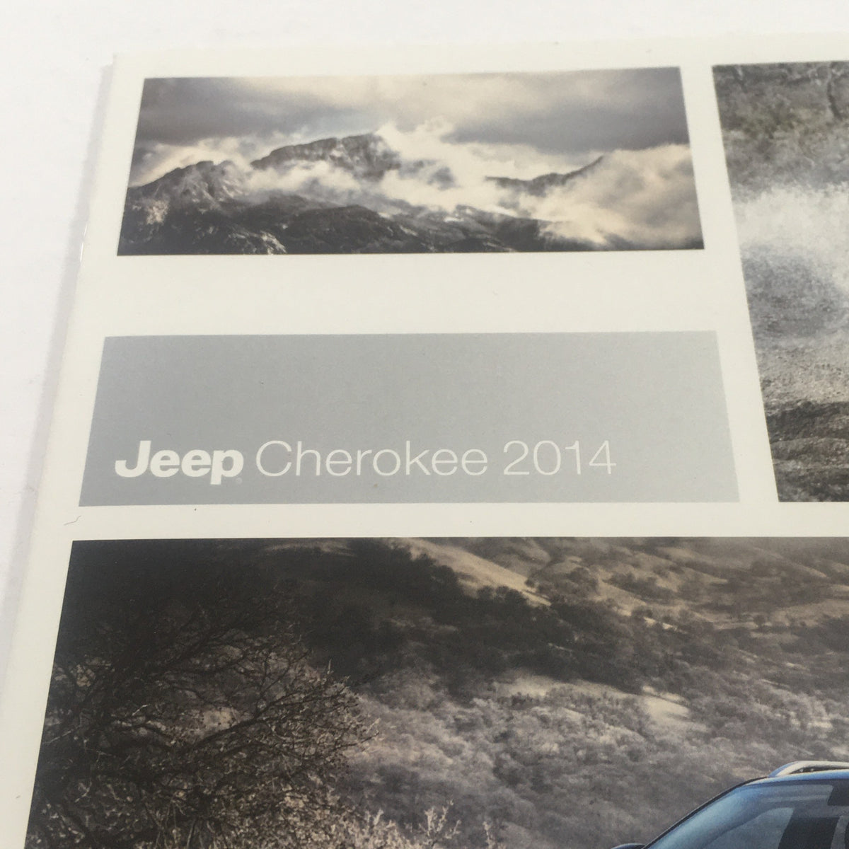 Cover of the 2014 Jeep Cherokee 4x4 Dealership Car Auto Brochure Catalog featuring scenic mountain landscape and Jeep logo.