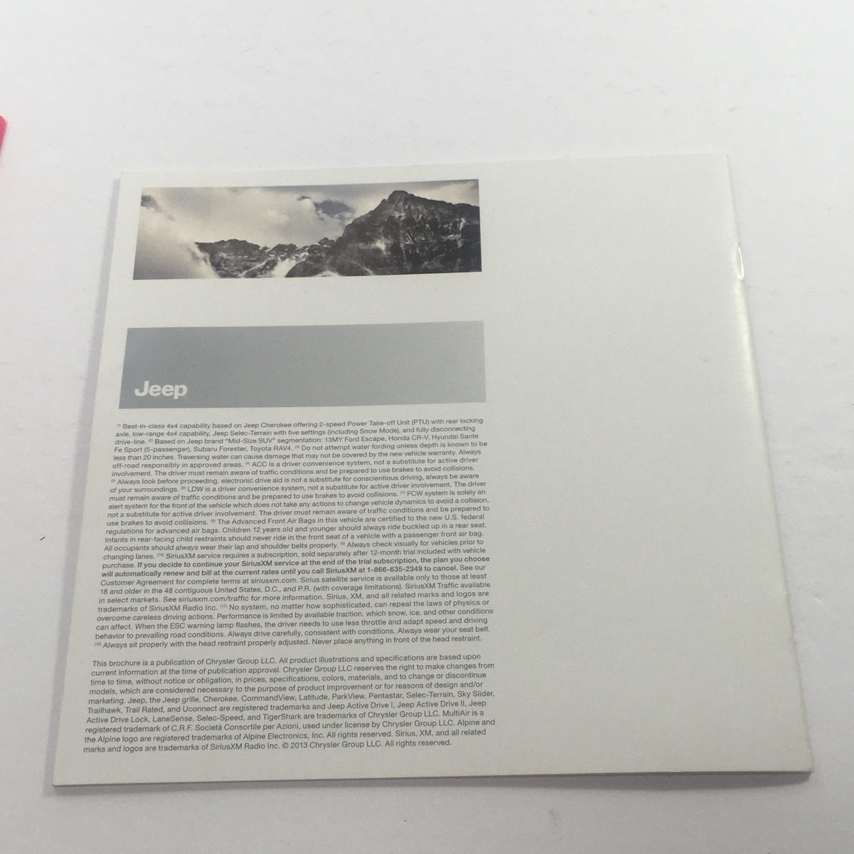 Back cover of the 2014 Jeep Cherokee 4x4 Dealership Car Auto Brochure Catalog, featuring mountain imagery and informational text about the Jeep brand.