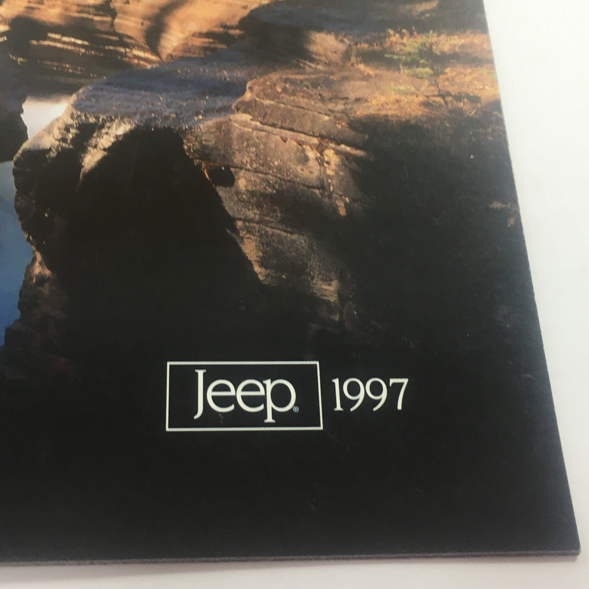 Close-up view of the 1997 Jeep 4-Wheel Drive Dealership Car Auto Brochure Catalog cover featuring the Jeep logo and year, emphasizing its collectible nature.