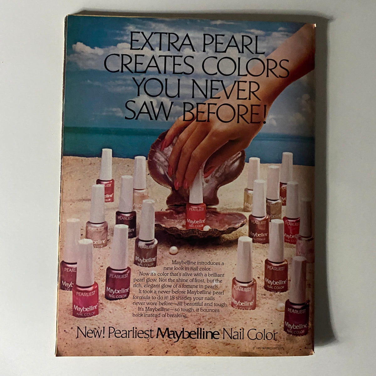 Vintage Maybelline advertisement for nail color featured in 16 Magazine, showcasing an array of pearl nail polish shades on a beach setting.