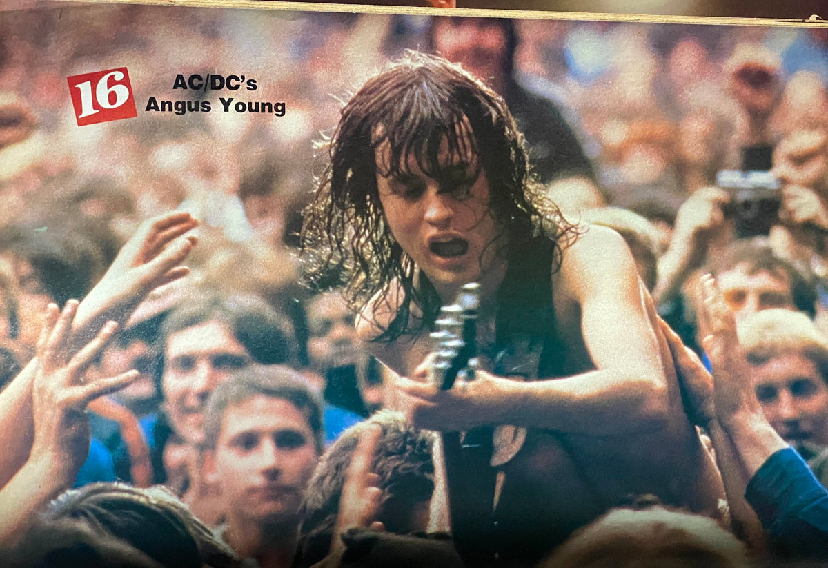 16 Magazine May 1982 featuring AC/DC's Angus Young performing to a crowd with fans reaching out.