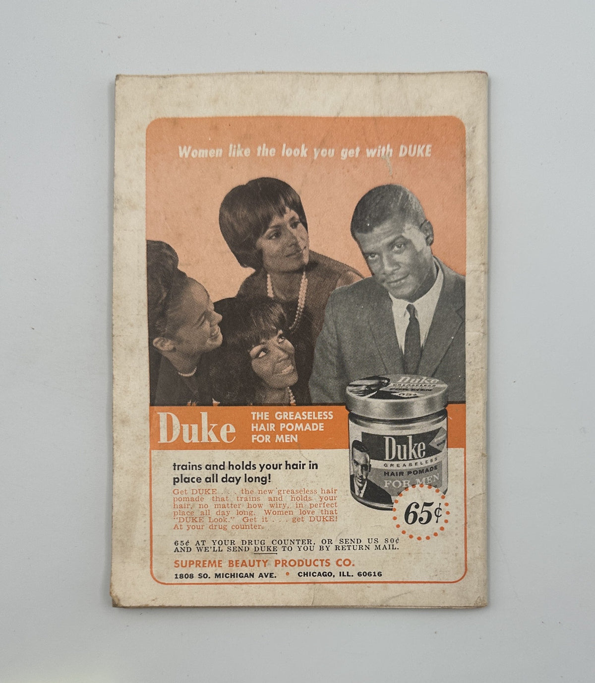 Advertisement page from Jet Magazine December 2, 1965, promoting Duke Hair Pomade for men, showcased with a group of models demonstrating the product.