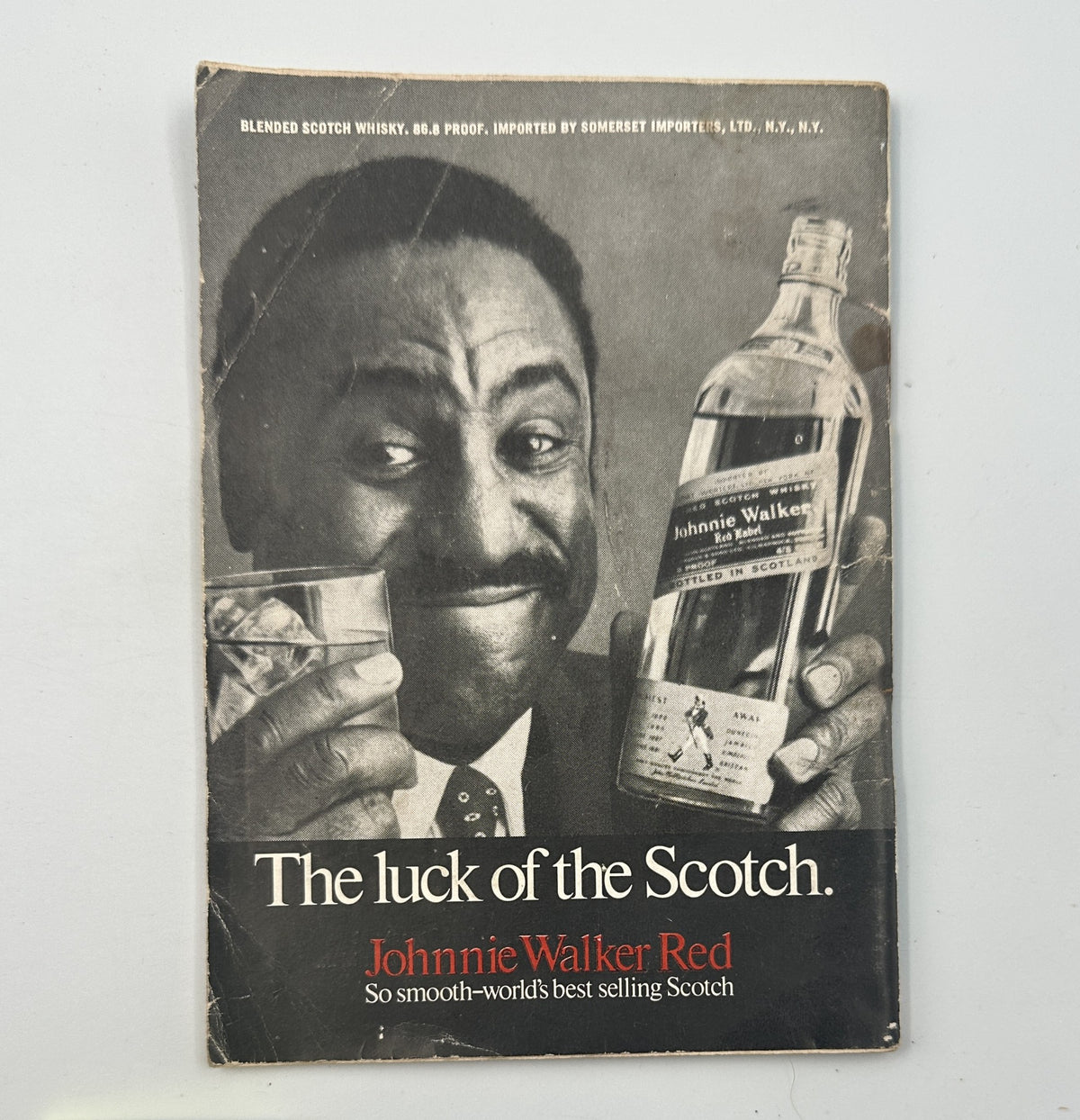 Advertisement for Johnnie Walker Red Scotch from the 1969 era, featuring a smiling man holding a bottle, promoting it as the world's best-selling Scotch.