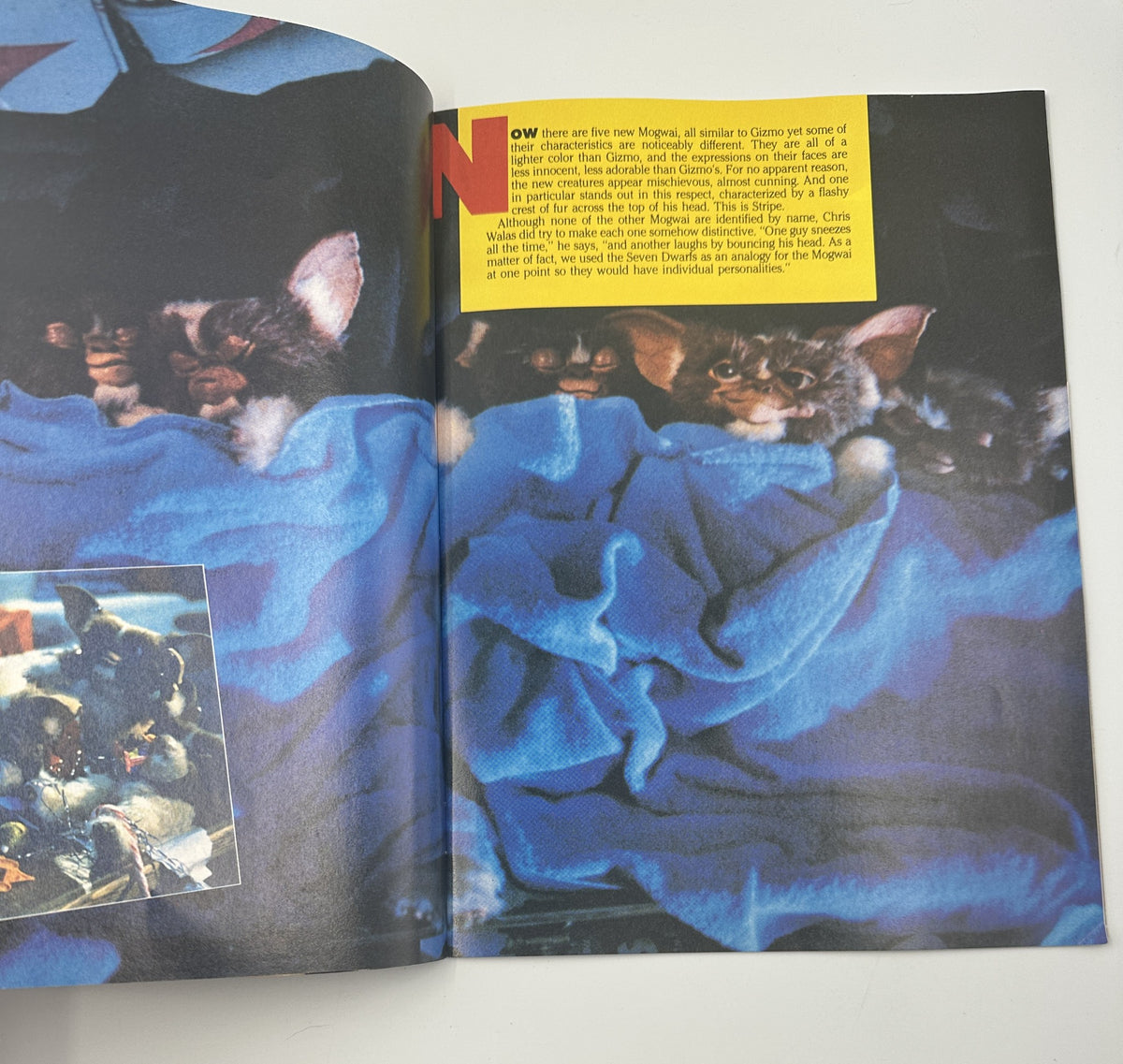 Page from the Gremlins Souvenir Magazine Official Collector’s Edition showcasing Gremlins cuddling under blue blankets, illustrating key characters and their charm.