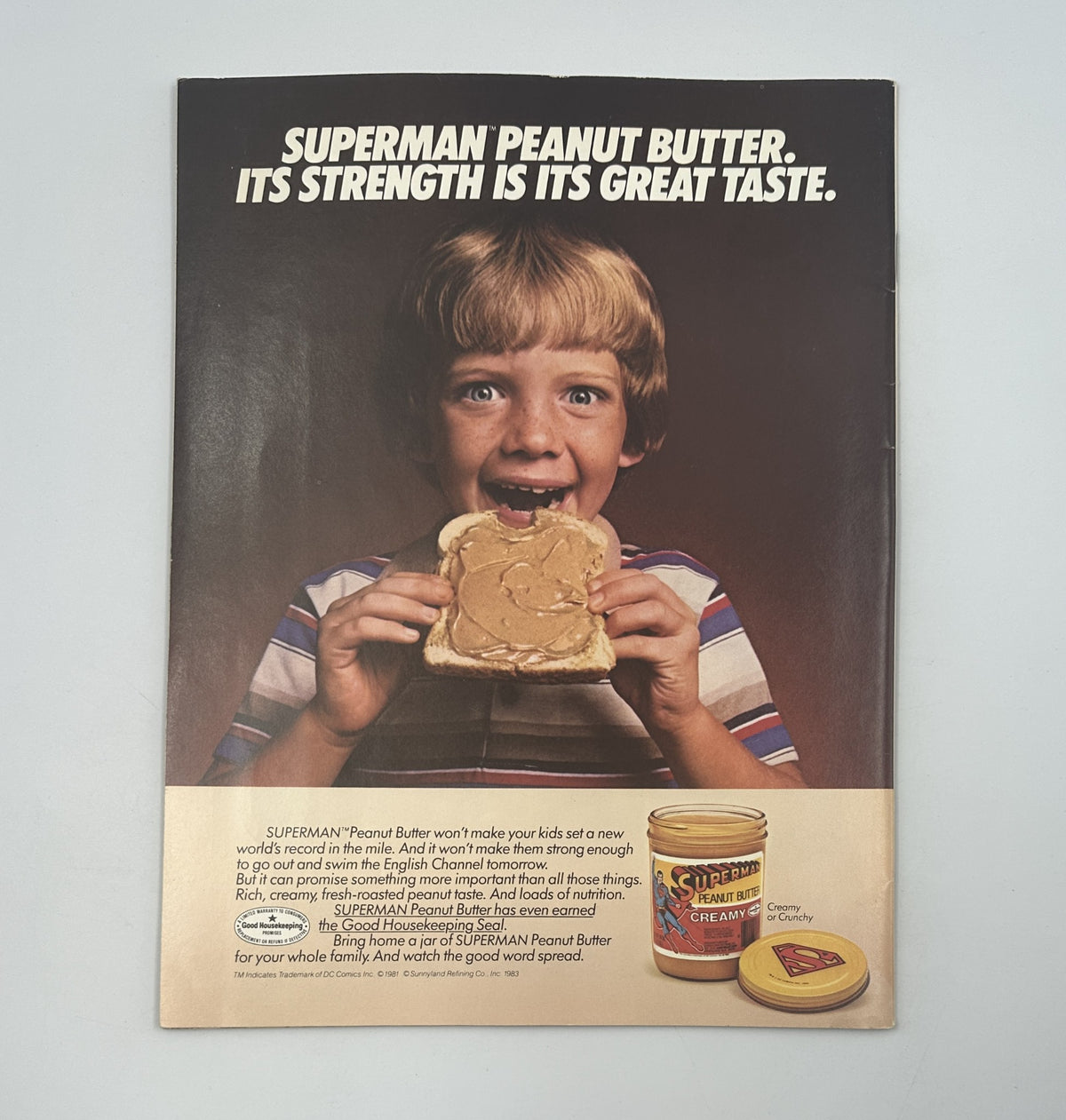 Back cover of a promotional advertisement for Superman Peanut Butter featuring a young boy enjoying a peanut butter sandwich.