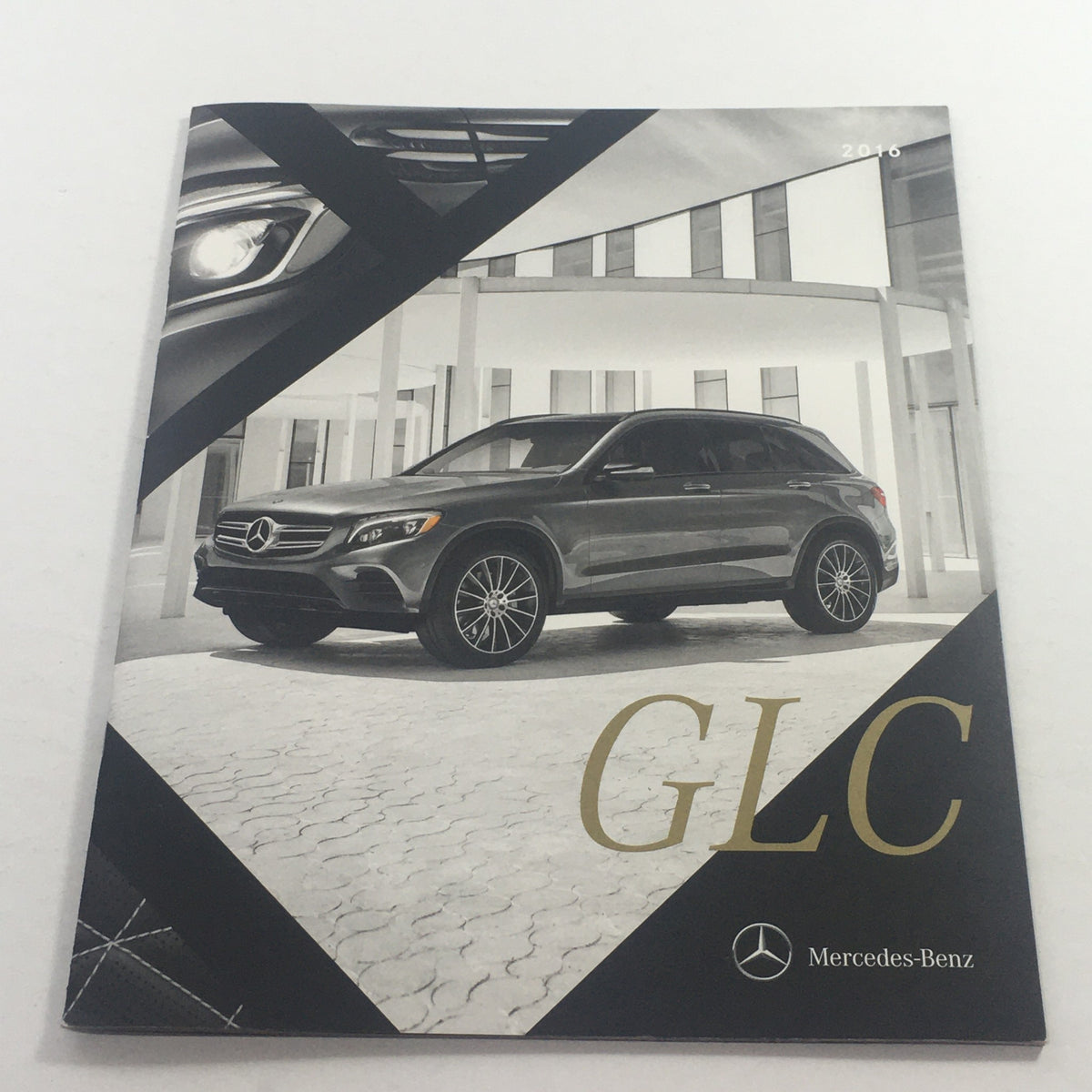 2016 Mercedes-Benz GLC-Class Polished Mettle Dealership Auto Brochure Catalog cover featuring a sleek grey GLC vehicle set against a modern architectural background, highlighting the luxury design.