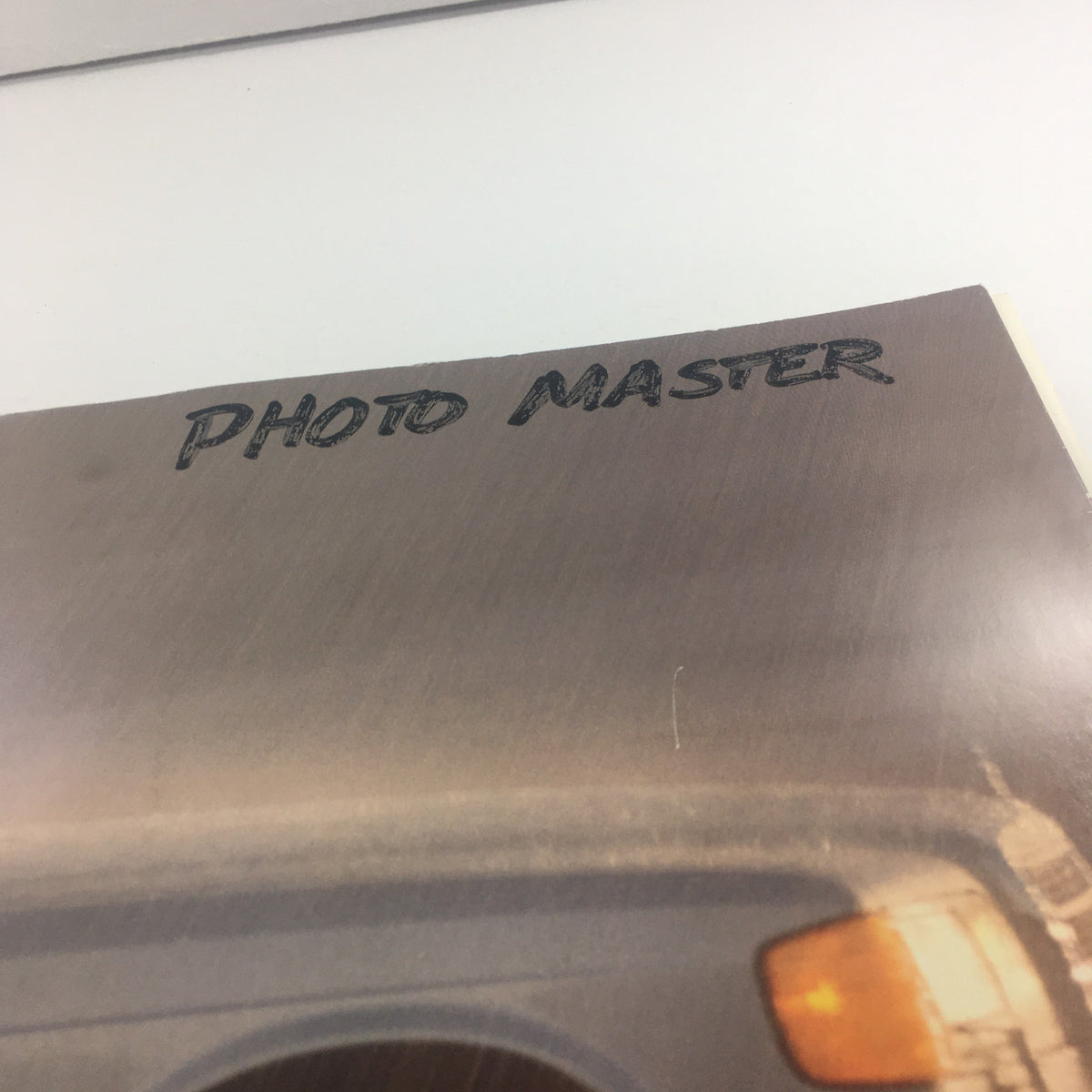 Close-up of the cover of the 1991 Mercedes-Benz S-Class 300 SE-Sedan Dealership Car Auto Brochure Catalog, showing 'PHOTO MASTER' handwritten on the cover.