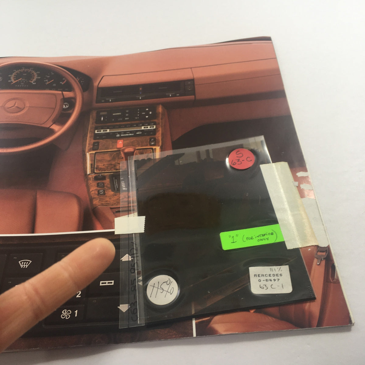 Detailed view of the interior section of a 1991 Mercedes-Benz S-Class 300 SE-Sedan Dealership Car Auto Brochure Catalog featuring dashboard controls.