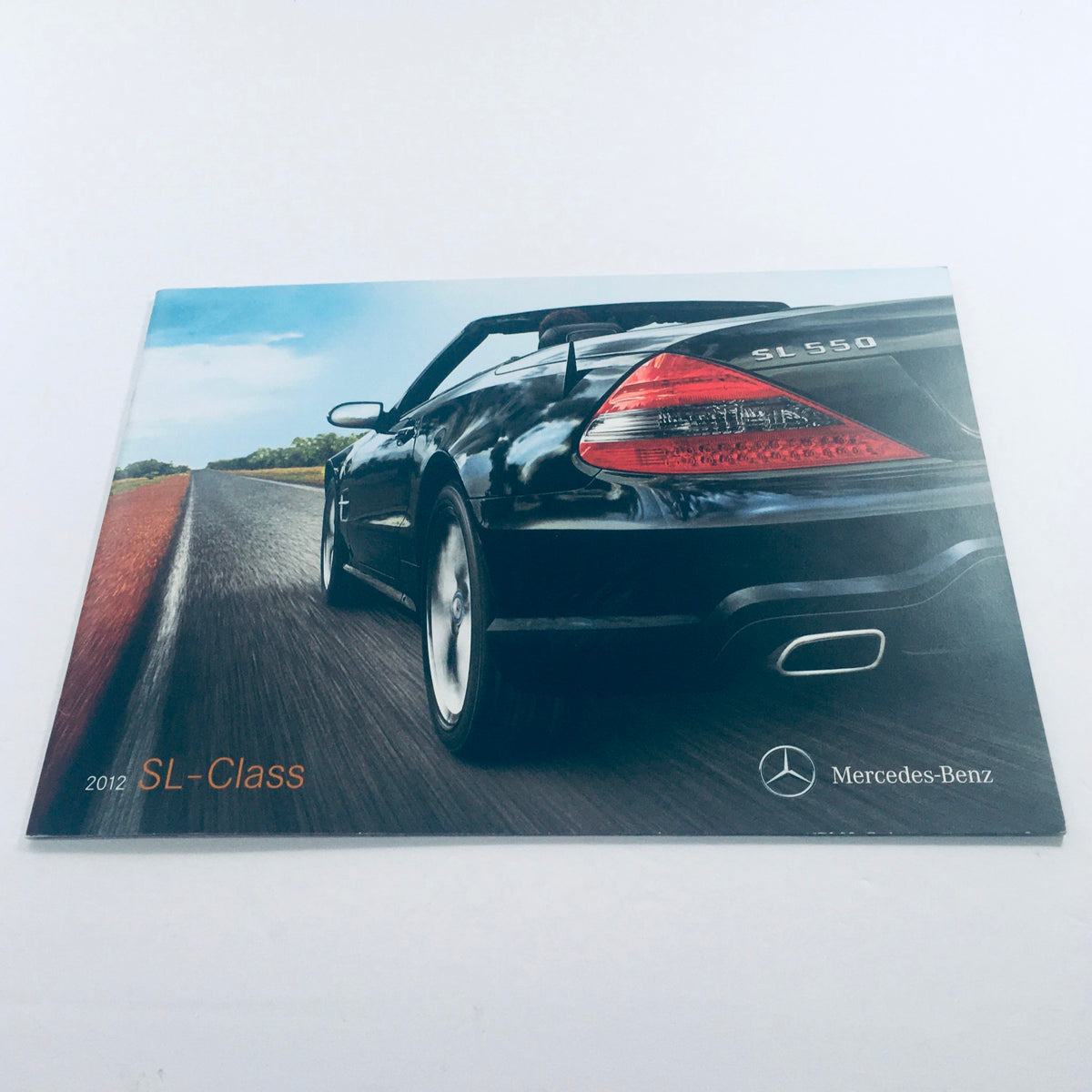 2012 Mercedes-Benz SL-Class Dealership Car Auto Brochure Catalog showcasing the rear of an SL-Class model driving on a scenic road.