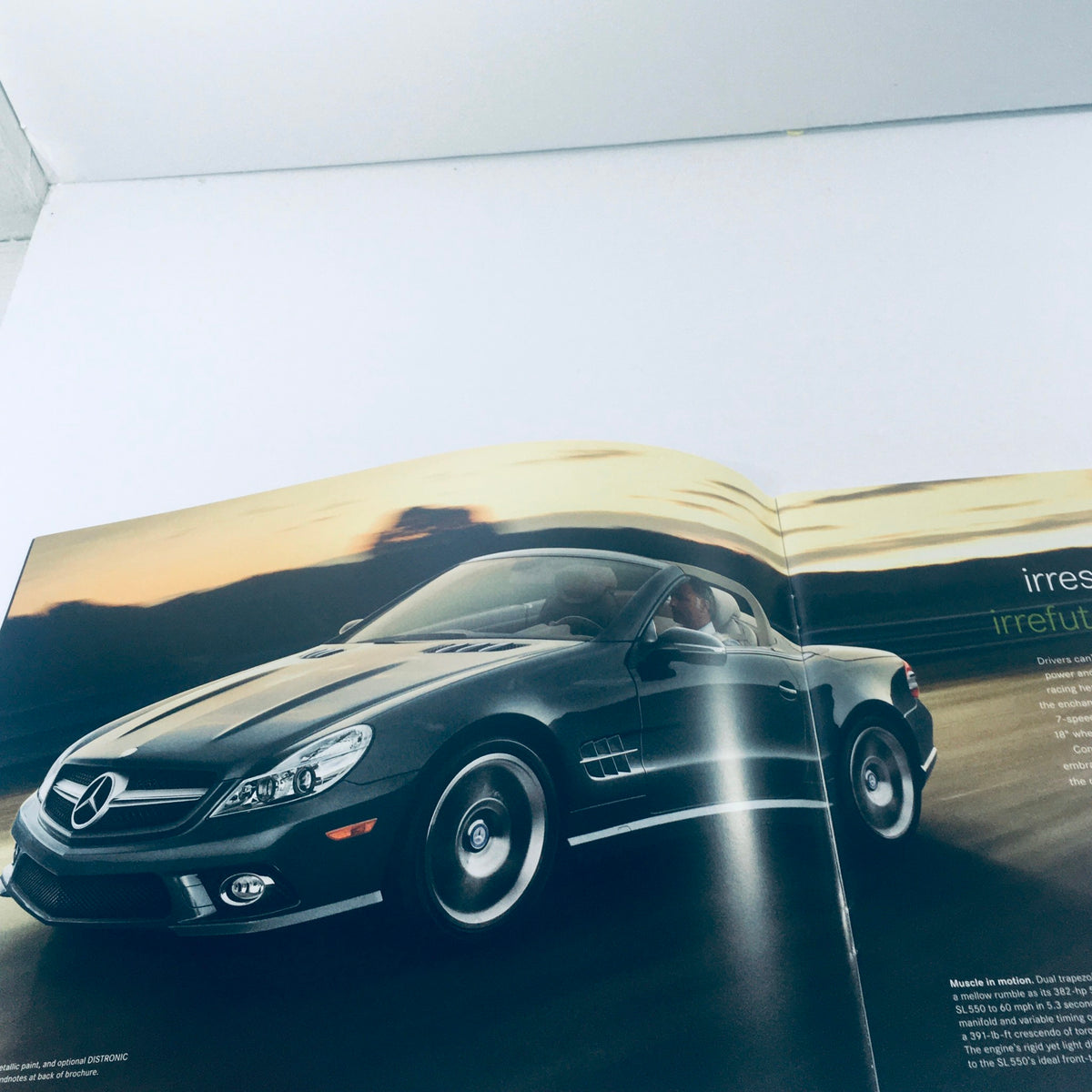 Interior page of the 2012 Mercedes-Benz SL-Class Dealership Car Auto Brochure displaying a stylish SL-Class model in motion.