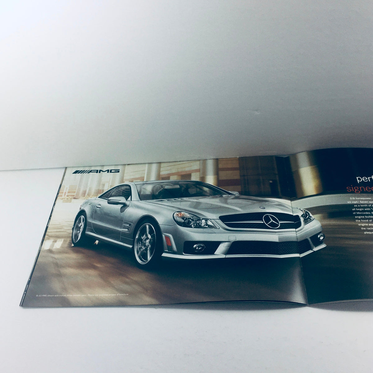 2012 Mercedes-Benz SL-Class Dealership Car Auto Brochure Catalog featuring a silver car in a modern showroom setting.