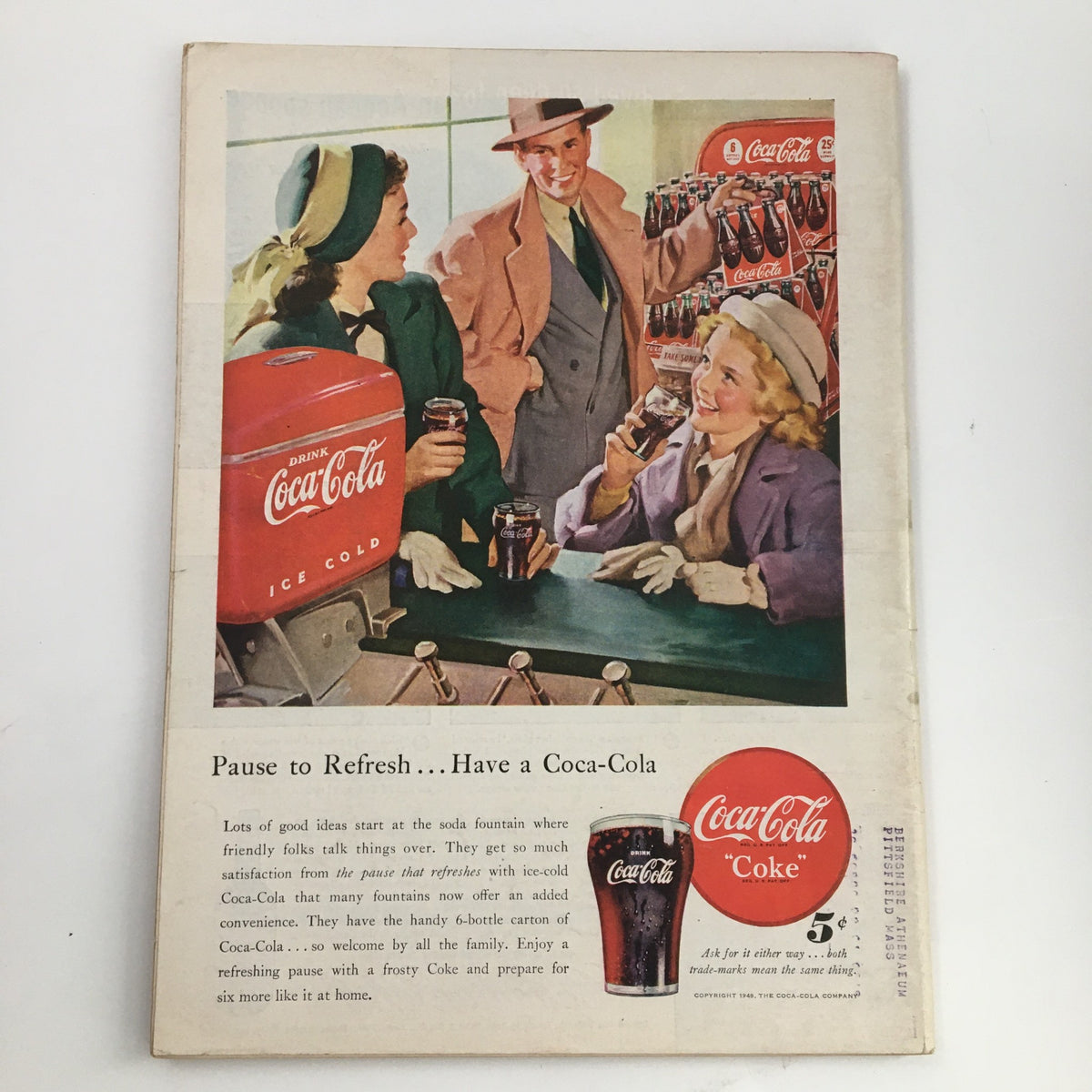 Back cover advertisement for Coca-Cola from a vintage magazine, highlighting a social scene with people enjoying drinks, reflecting mid-20th century American culture.