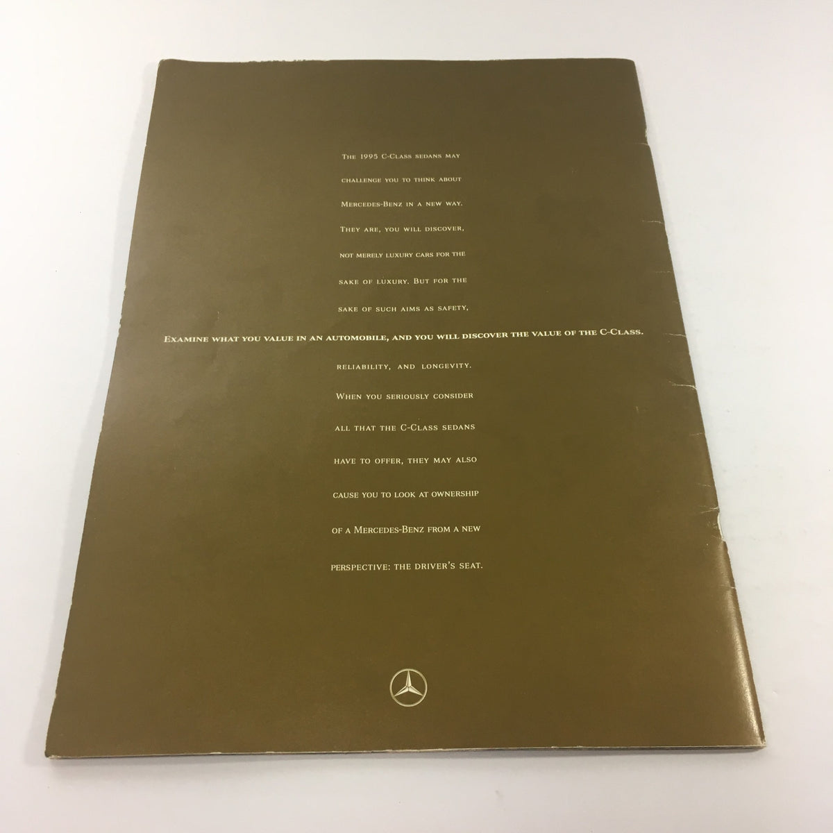 1995 Mercedes-Benz C-Class Sedan Dealership Car Auto Brochure Catalog, featuring a sophisticated gold cover with text outlining the luxury and value of the C-Class model.