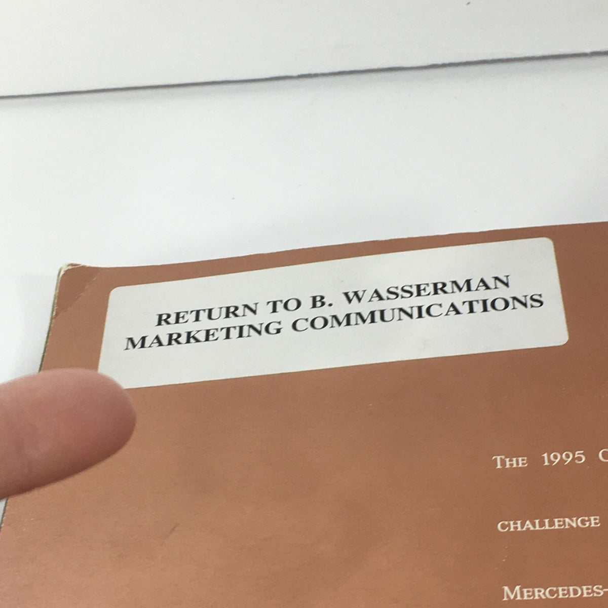 Close-up of the label on the back of the 1995 Mercedes-Benz C-Class C-36 Sedan Brochure, indicating the return address for B. Wasserman Marketing Communications.